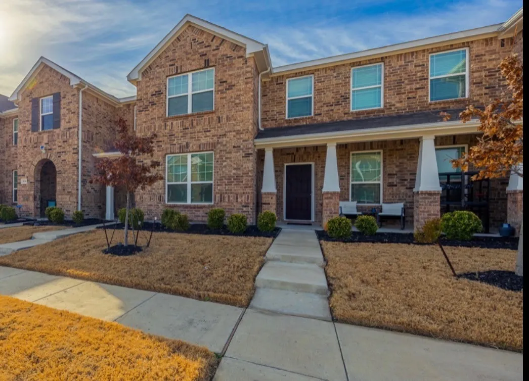 Brick exterior with a covered front porch featuring square columns