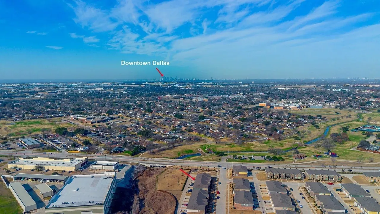 Expansive suburban landscape with distant downtown Dallas skyline