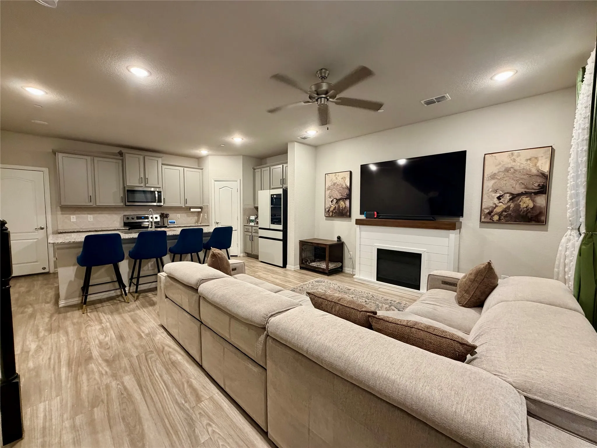 Open concept living space with wood-finish flooring