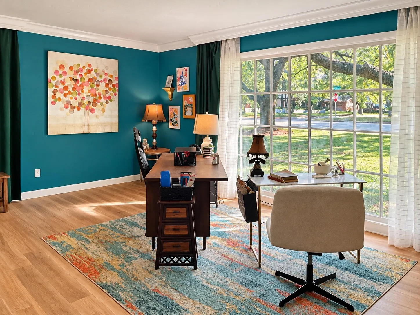 Expansive multi-pane window, wood-finish flooring, crown molding, and a vibrant accent wall