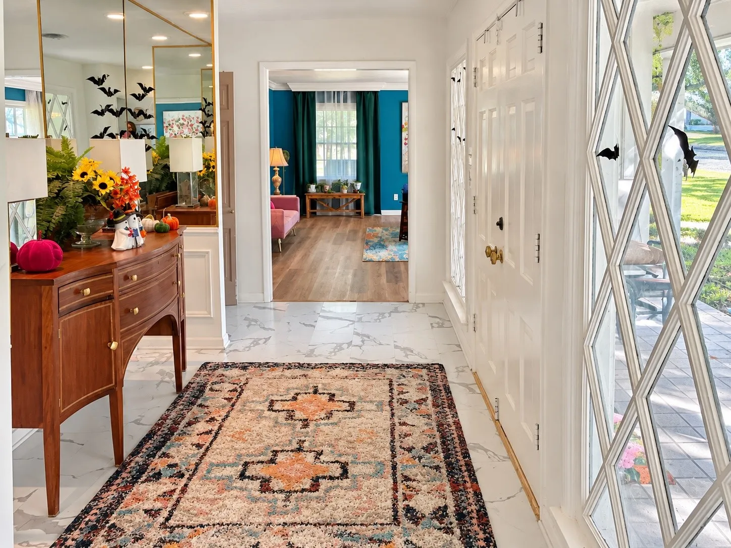 Entryway featuring white paneled door, diamond-paned sidelight, and marble-look flooring