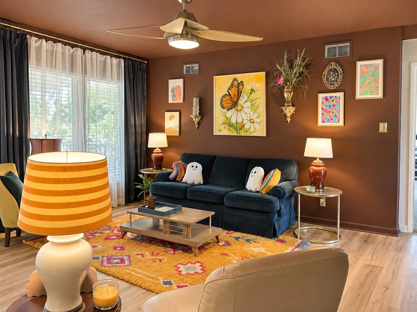 Warm-toned wall finish, recessed ceiling fan with integrated lighting, window with blinds and layered drapery, durable wood-finish flooring