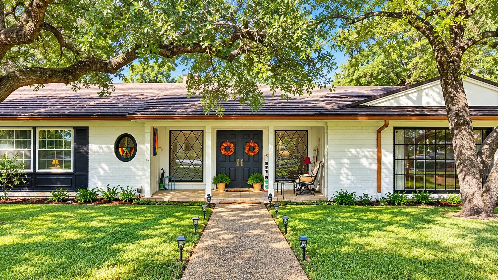 White painted brick exterior with dark trim and shutters