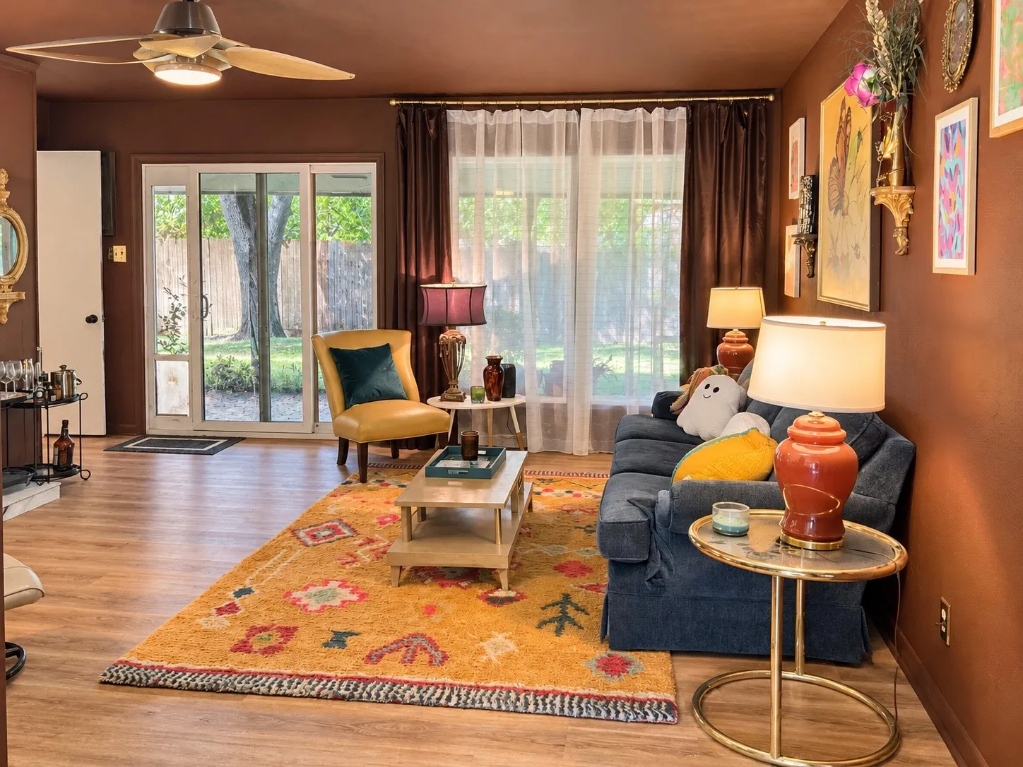 Wood-finish flooring throughout, with a ceiling fan featuring integrated lighting
