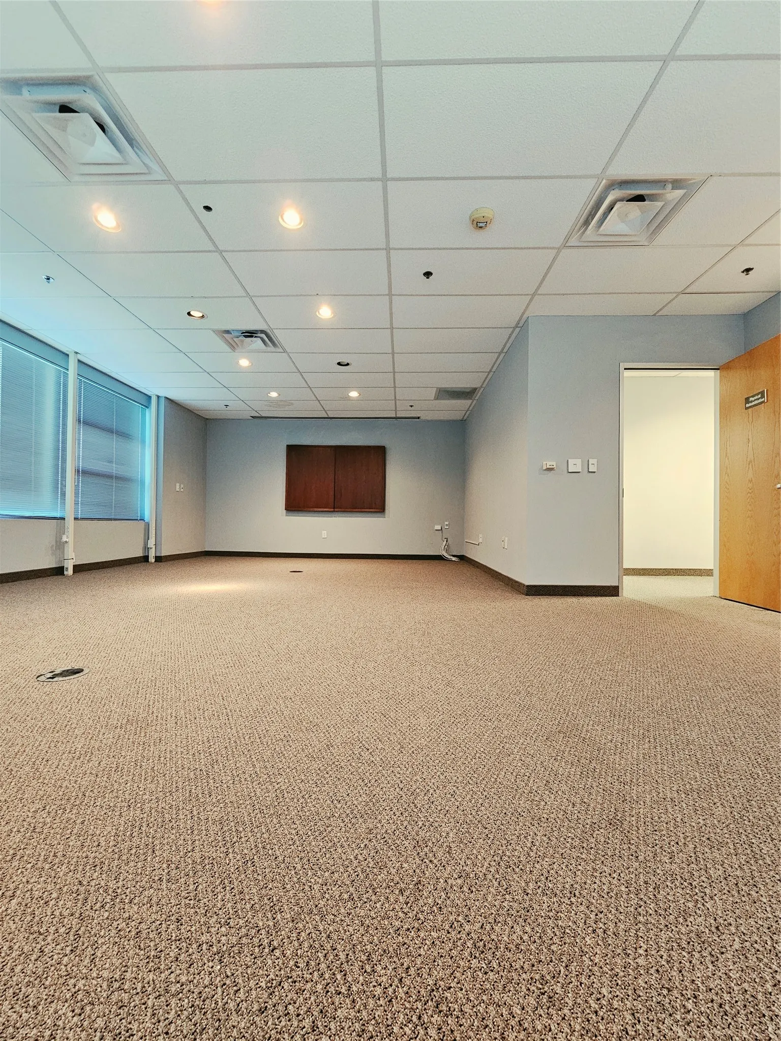 Recessed lighting, drop ceiling, carpeted flooring, window blinds, and built-in wall cabinetry