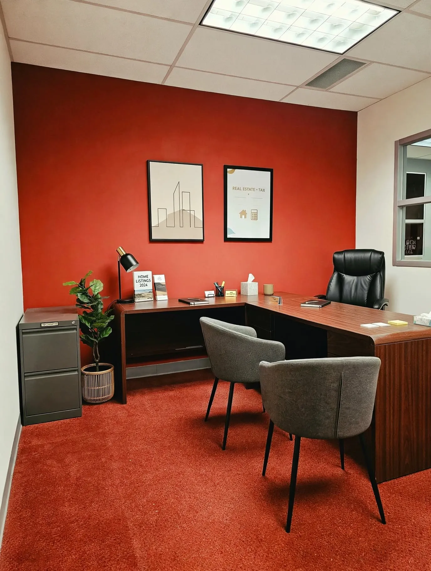 Recessed lighting, acoustic tile ceiling, window with white trim, red accent wall, and red carpeting