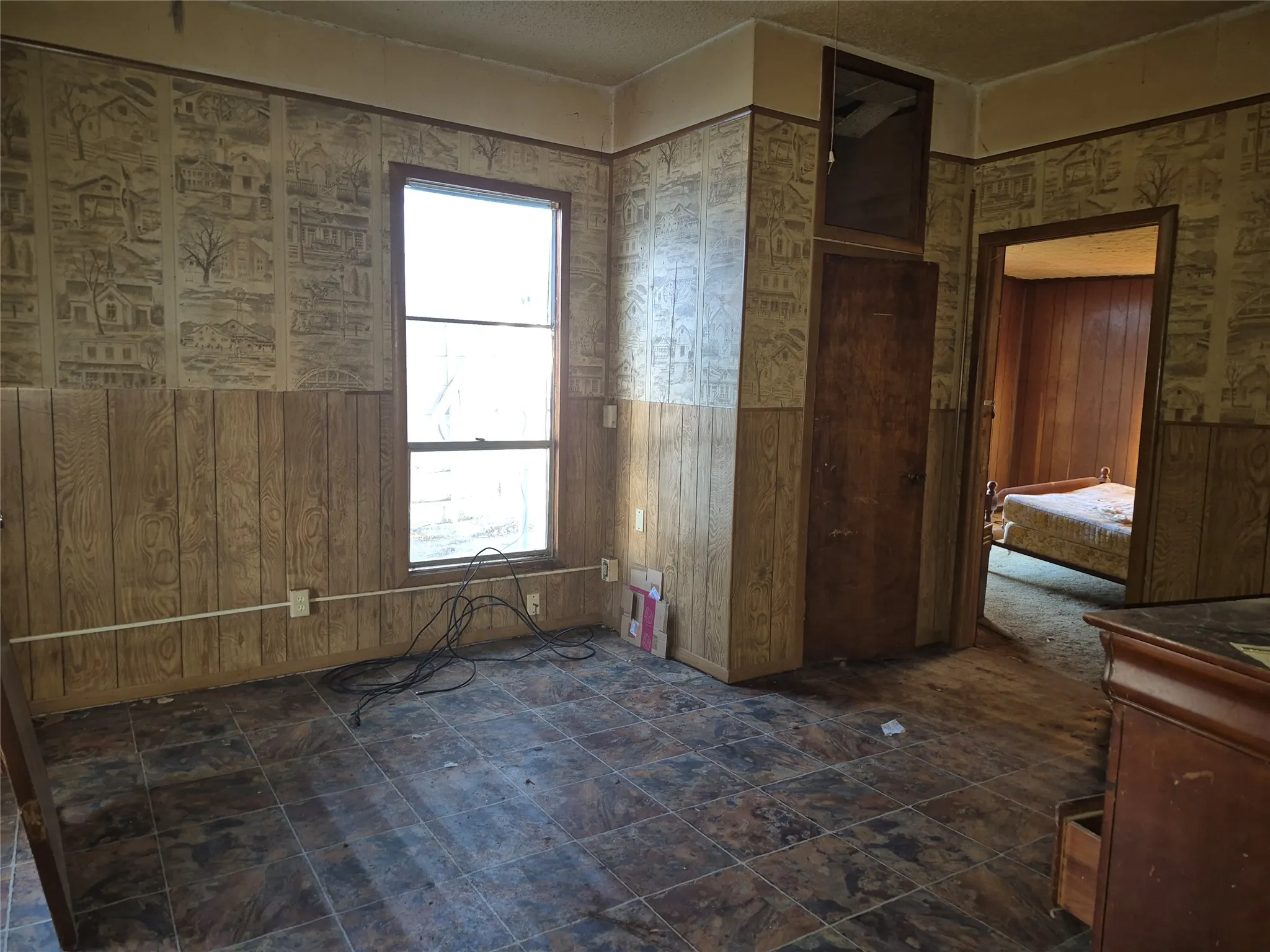 Room featuring tile flooring and wood-look paneling
