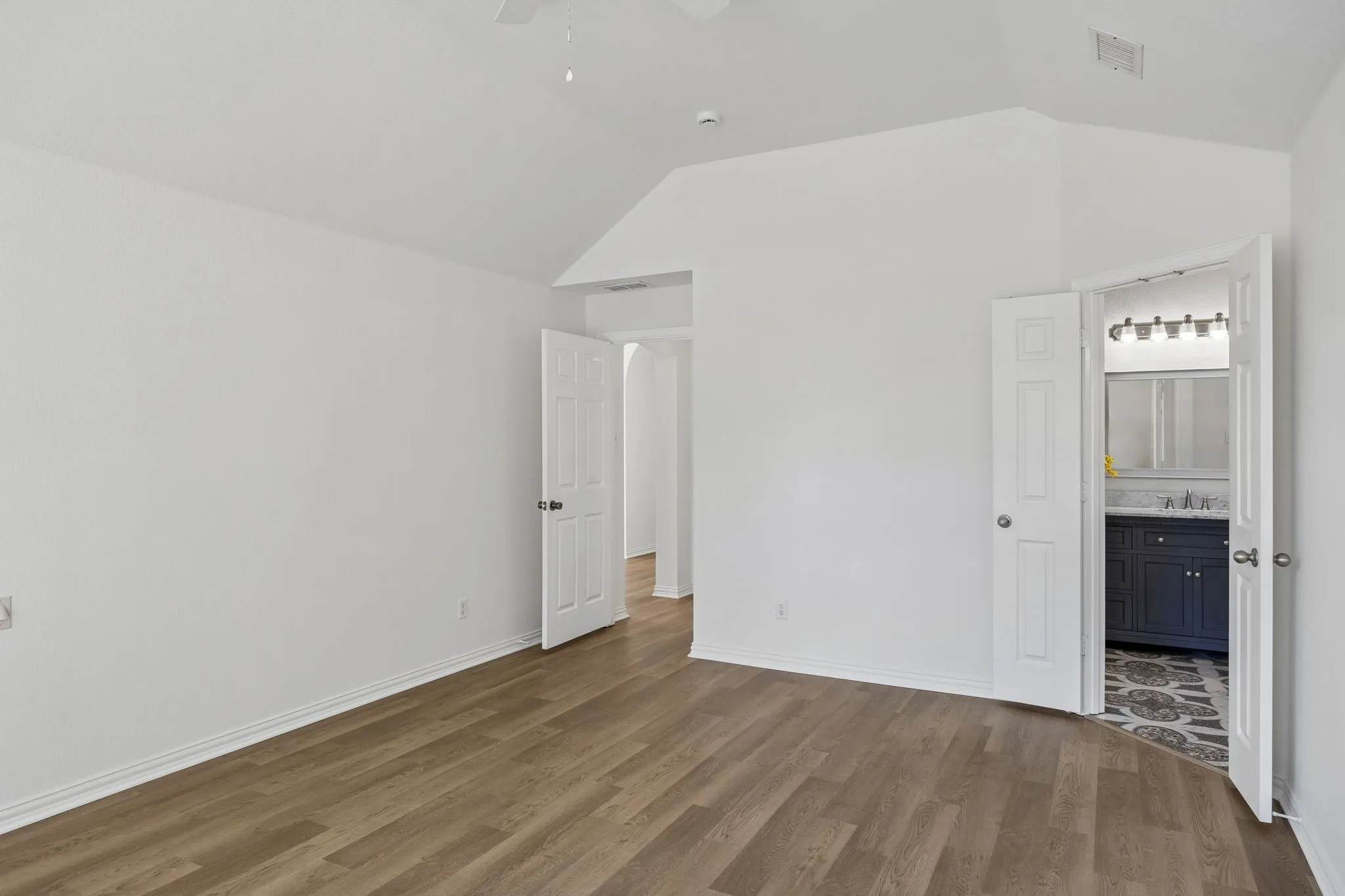 This impressive primary bedroom looks into its stunning ensuite!