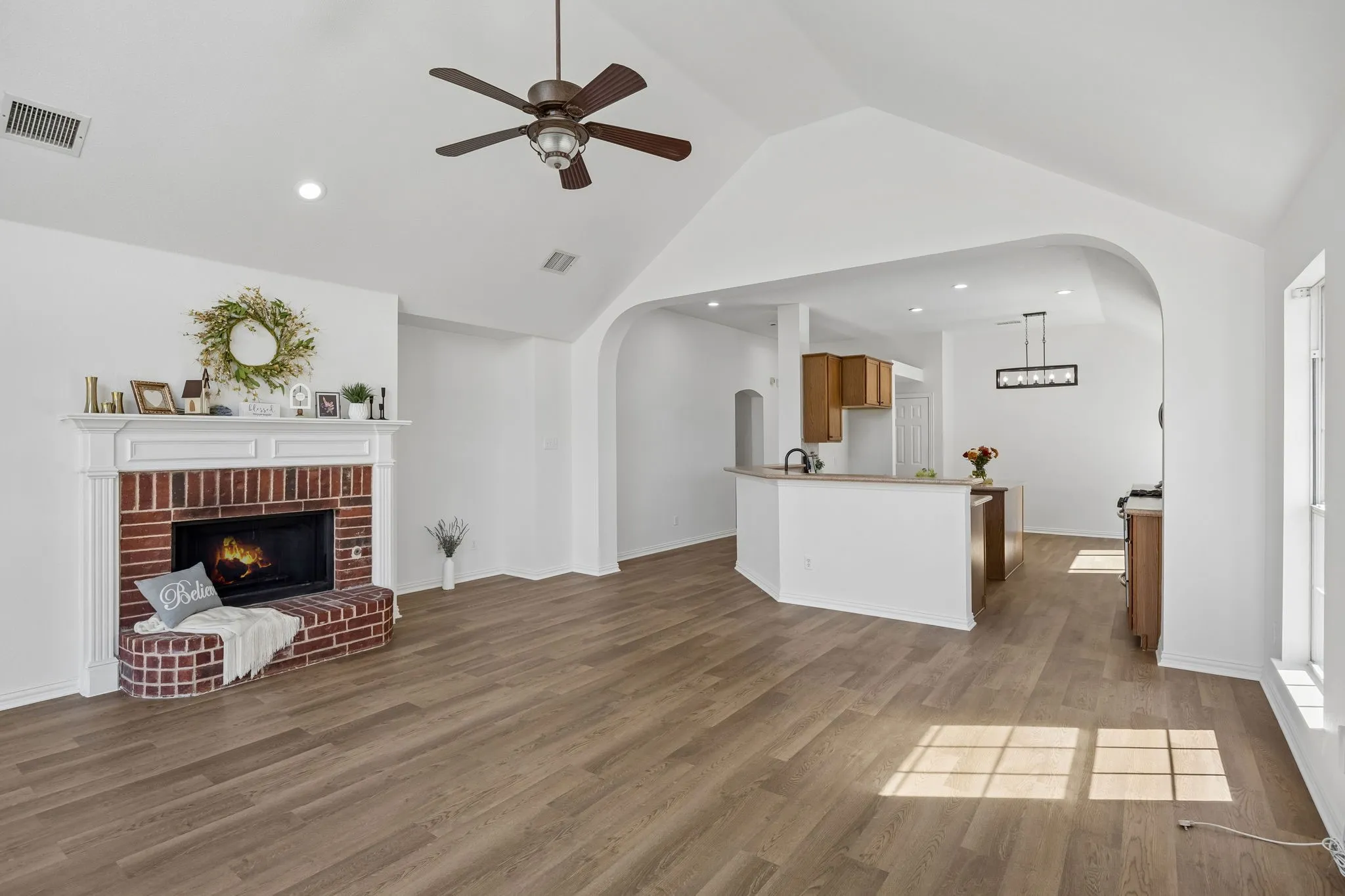 This photo captures the open and bright concept this home offers as well as the stunning vaulted ceiling, and architectural details that bring the warmth to this home - family and friends alike will love spending time here!