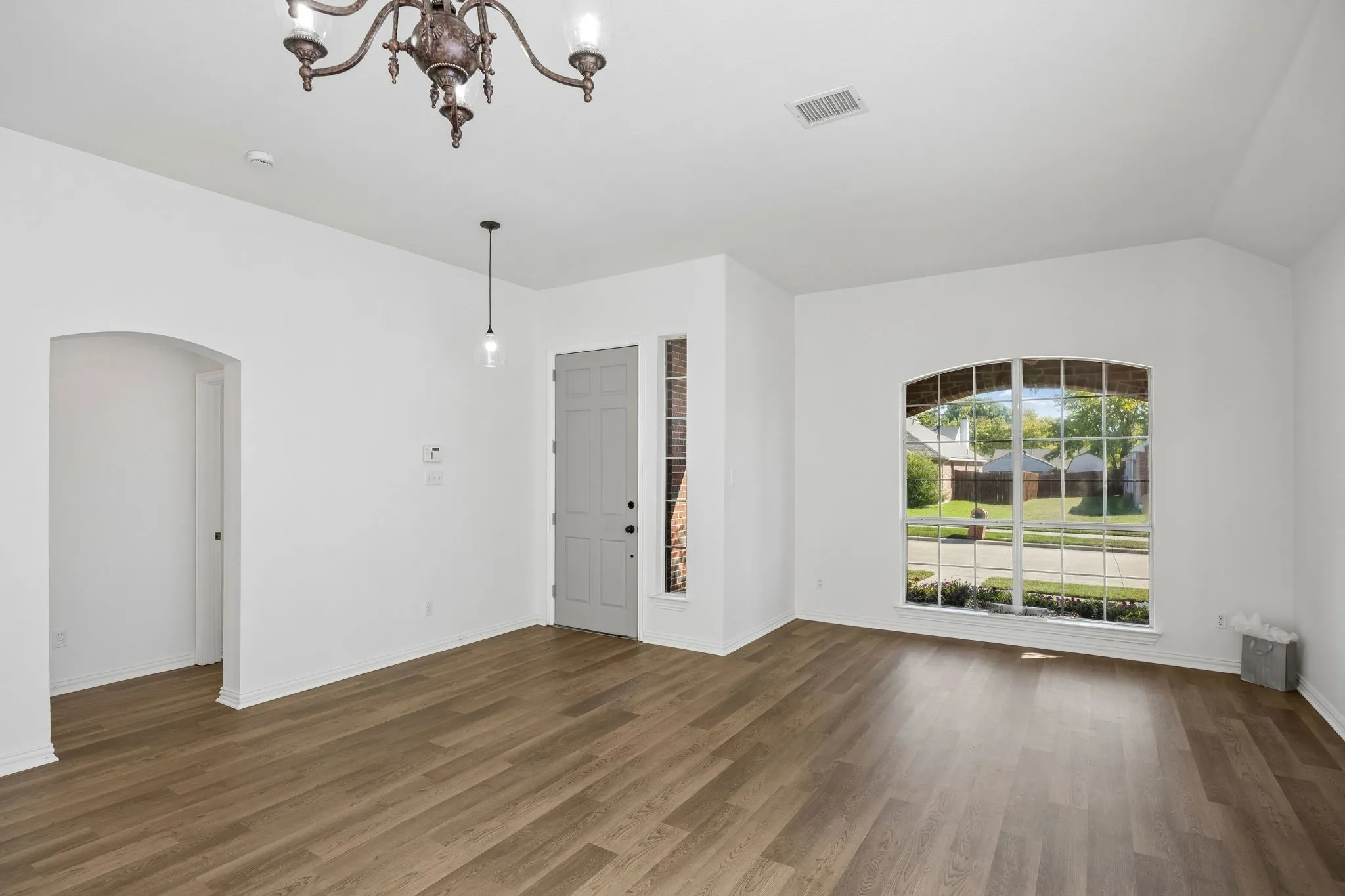 This view shows just how spacious the "formal dining and 2nd living area truly is.  Don't miss the warm and inviting luxury vinyl plank flooring!