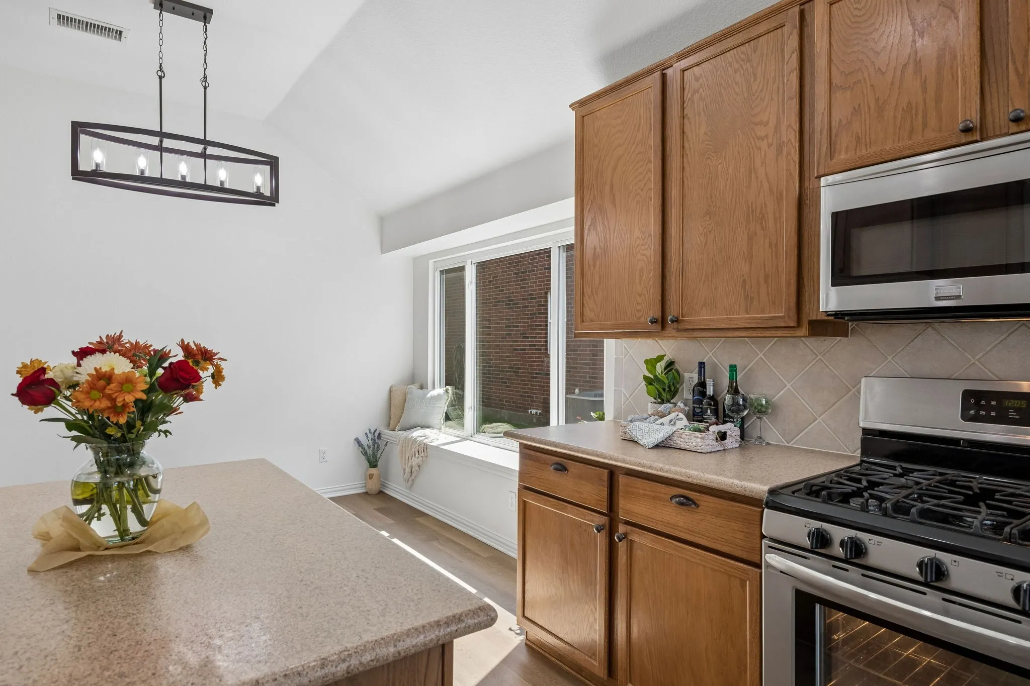 This view shows the beautiful counter tops, lovely backsplash and cabinetry as we look towards the breakfast room!