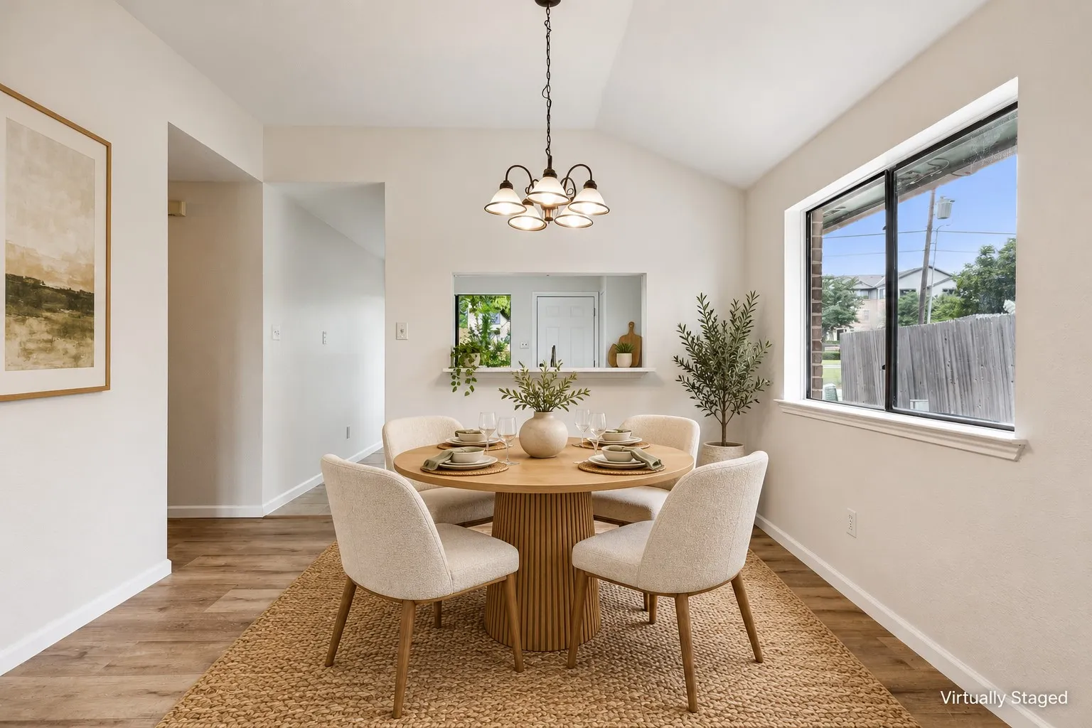 Vaulted ceiling, wood-finish flooring, recessed pass-through window, and a modern chandelier