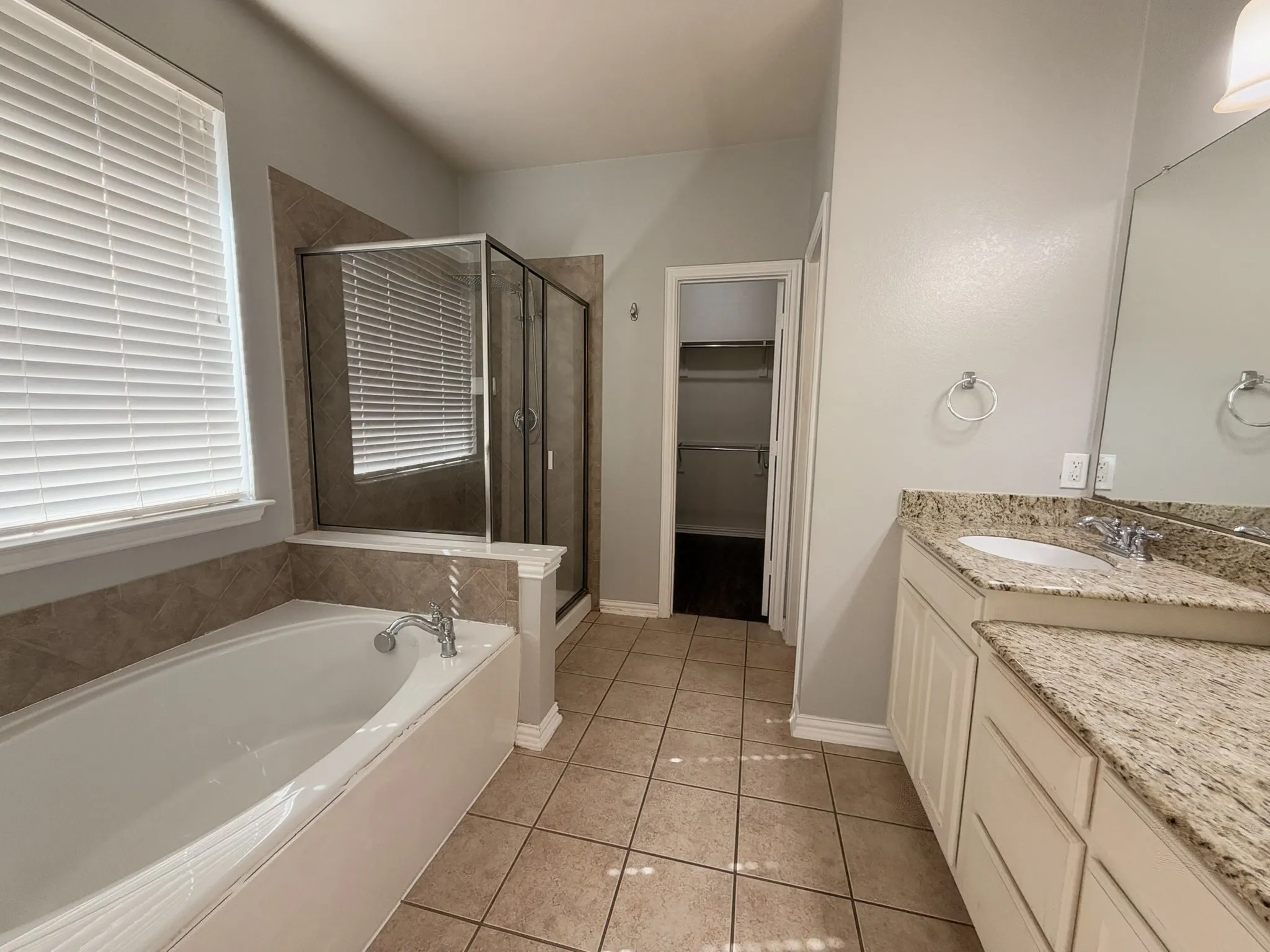 Dual vanity with stone countertops and undermount sinks