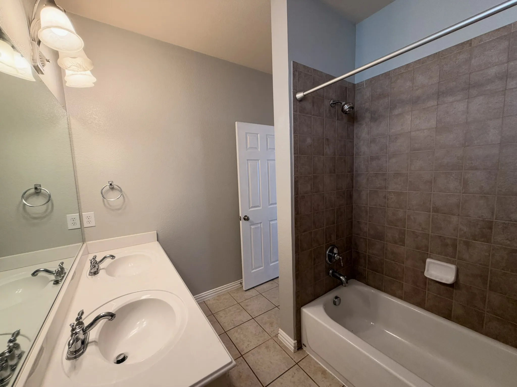 Dual vanity with chrome fixtures and integrated sinks