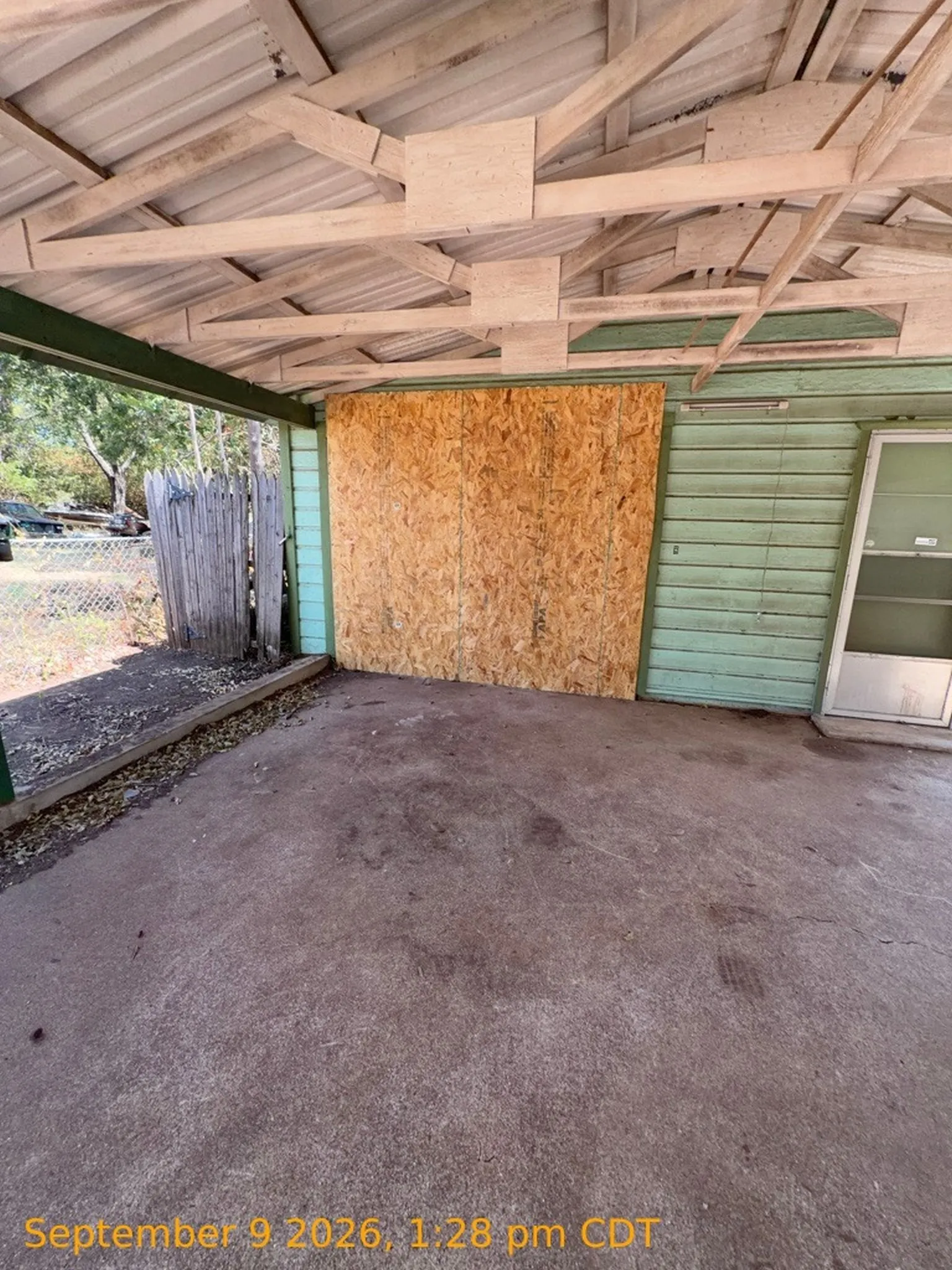 Covered patio with a concrete surface and exposed wood rafter ceiling
