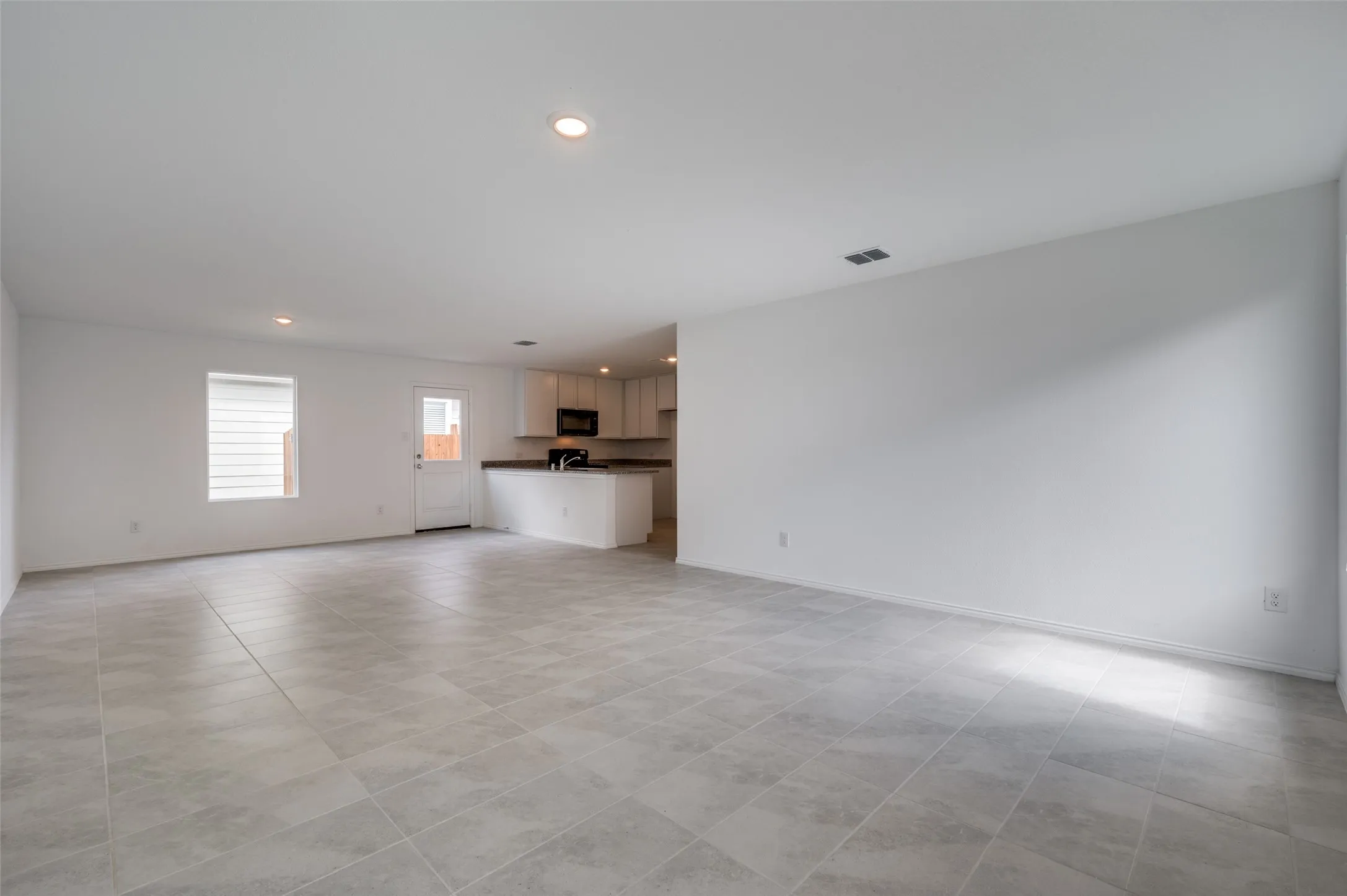 Unfurnished living room with light tile floors