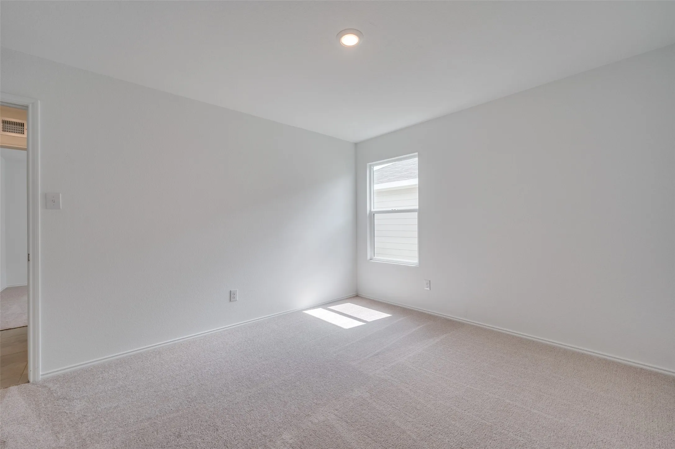 Spare room featuring carpet flooring