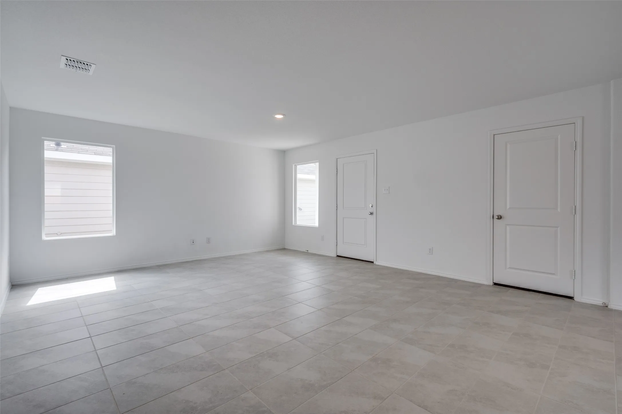 Spare room with light tile floors