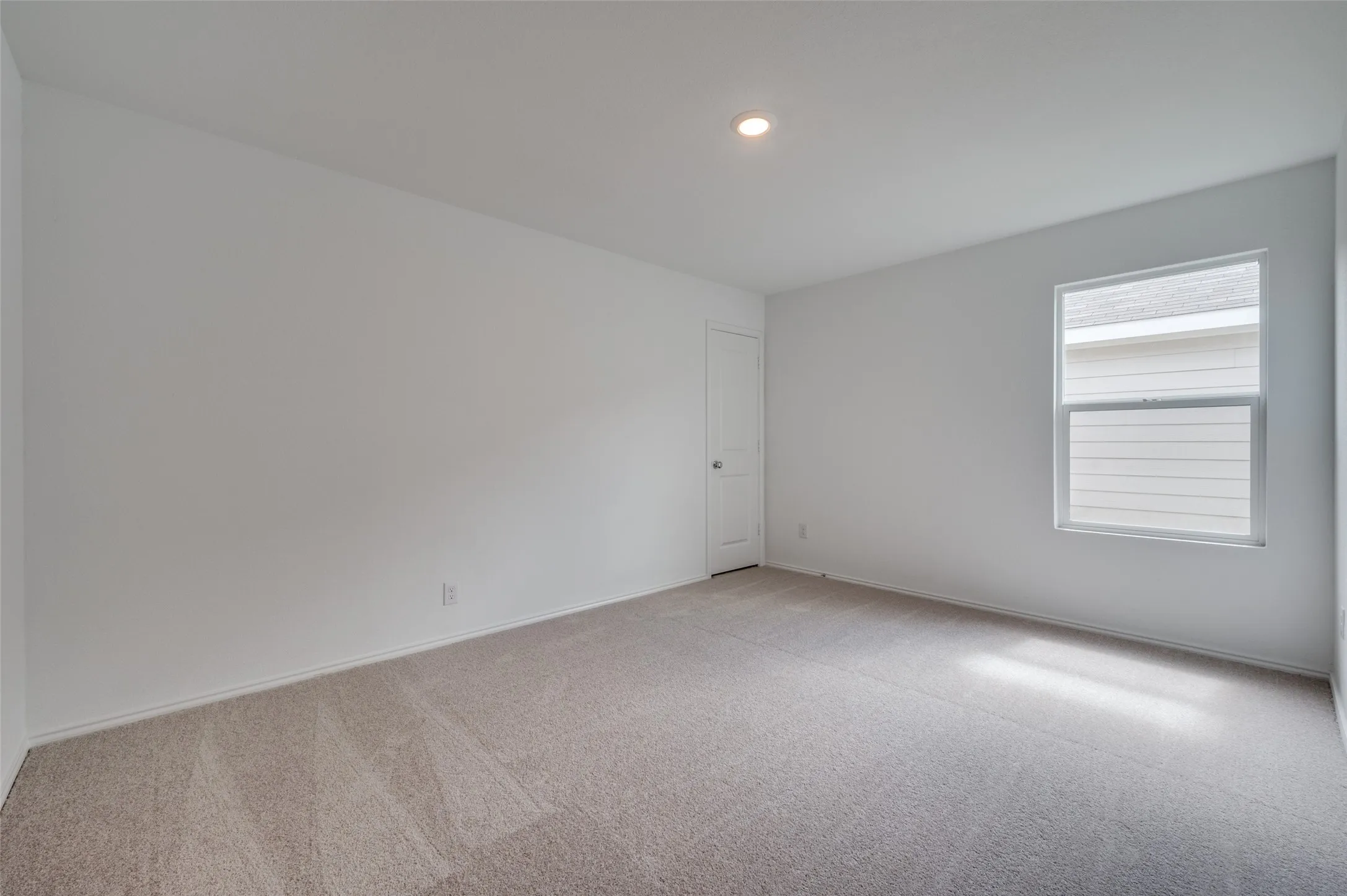 Unfurnished room with carpet flooring and plenty of natural light