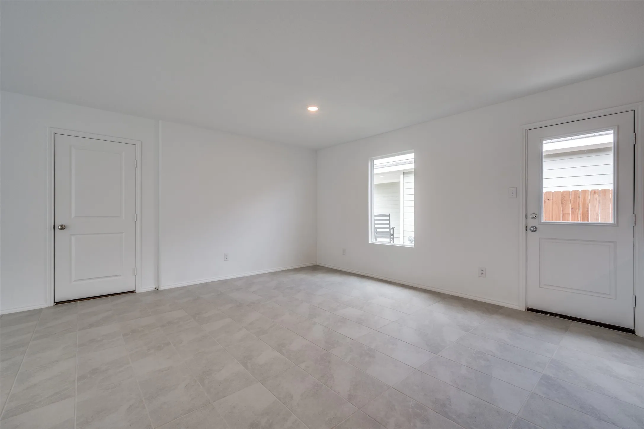 Tiled empty room with a healthy amount of sunlight