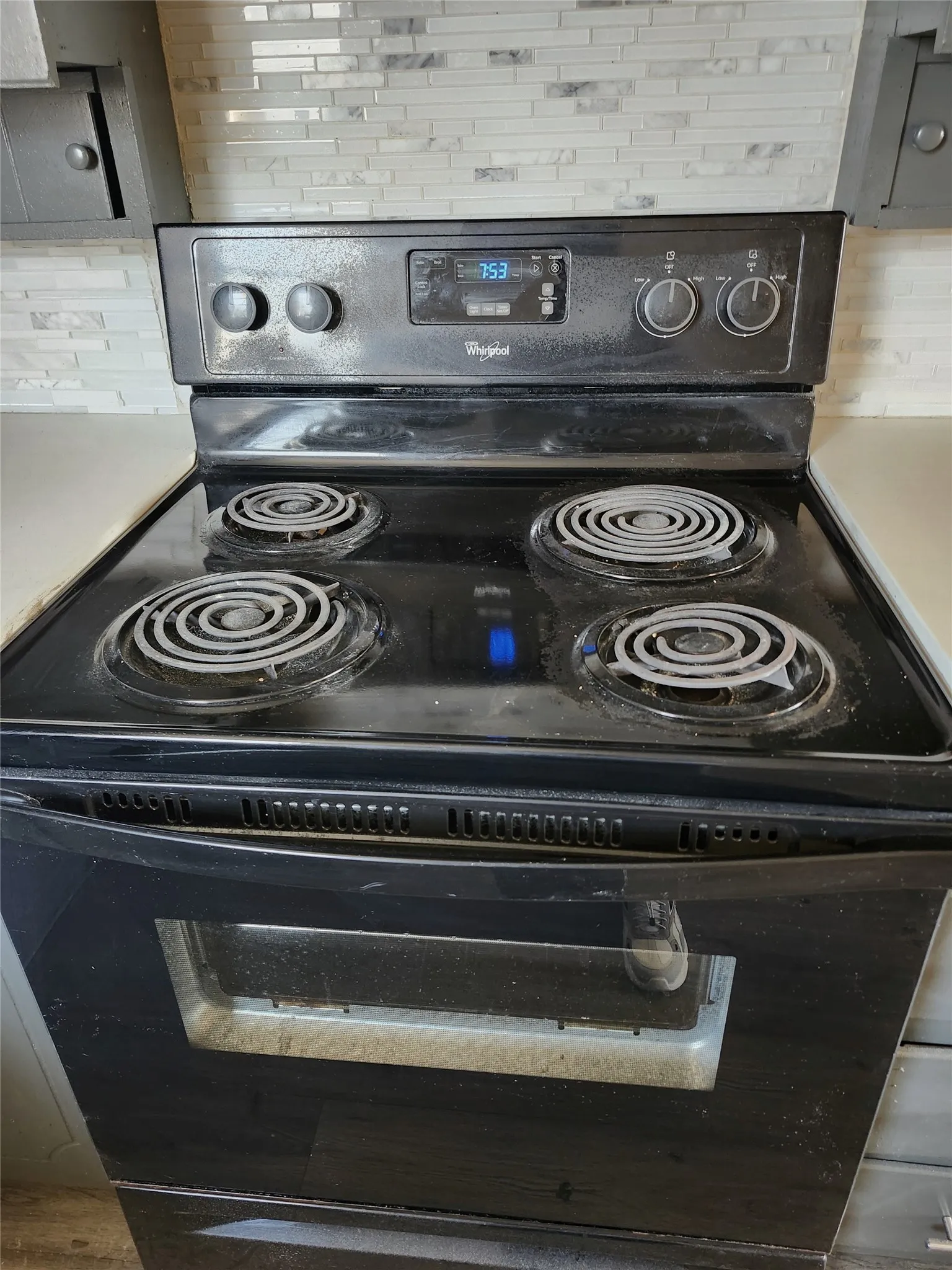 Black electric range with four coil burners