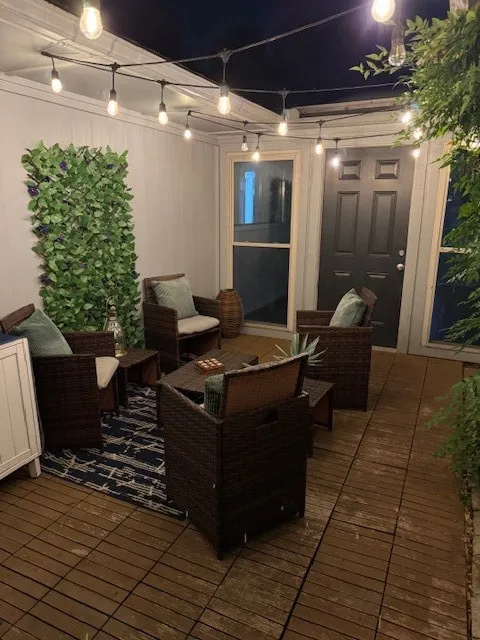 Deck at night with a patio area and an outdoor hangout area