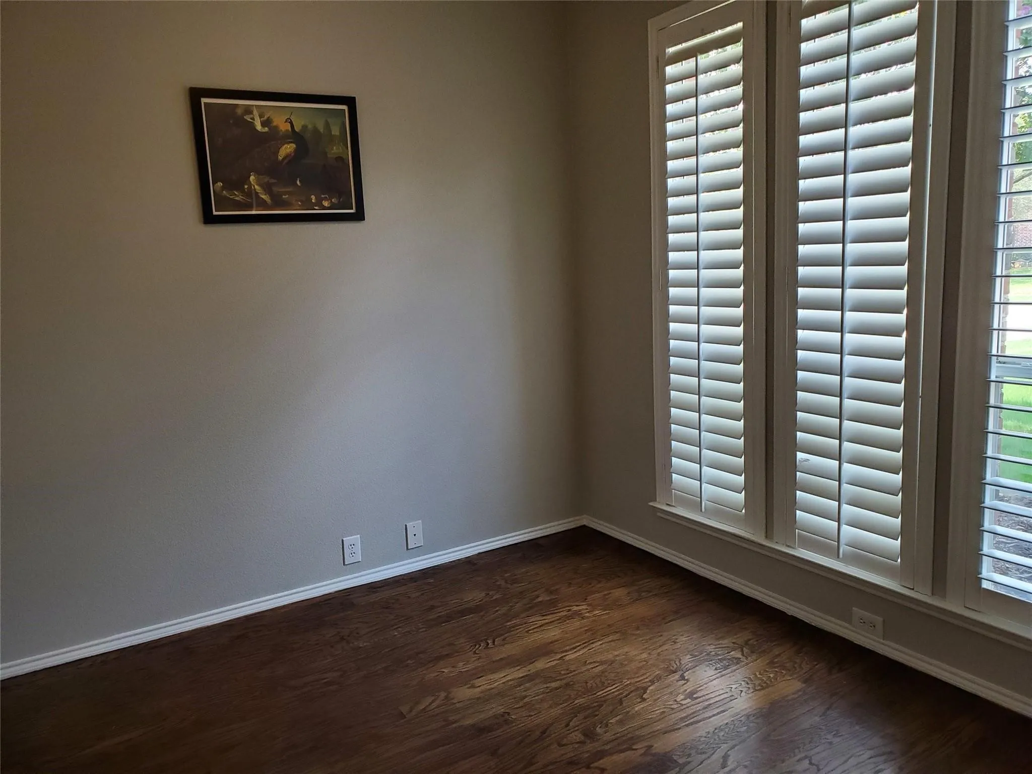 Unfurnished room featuring dark wood-type flooring