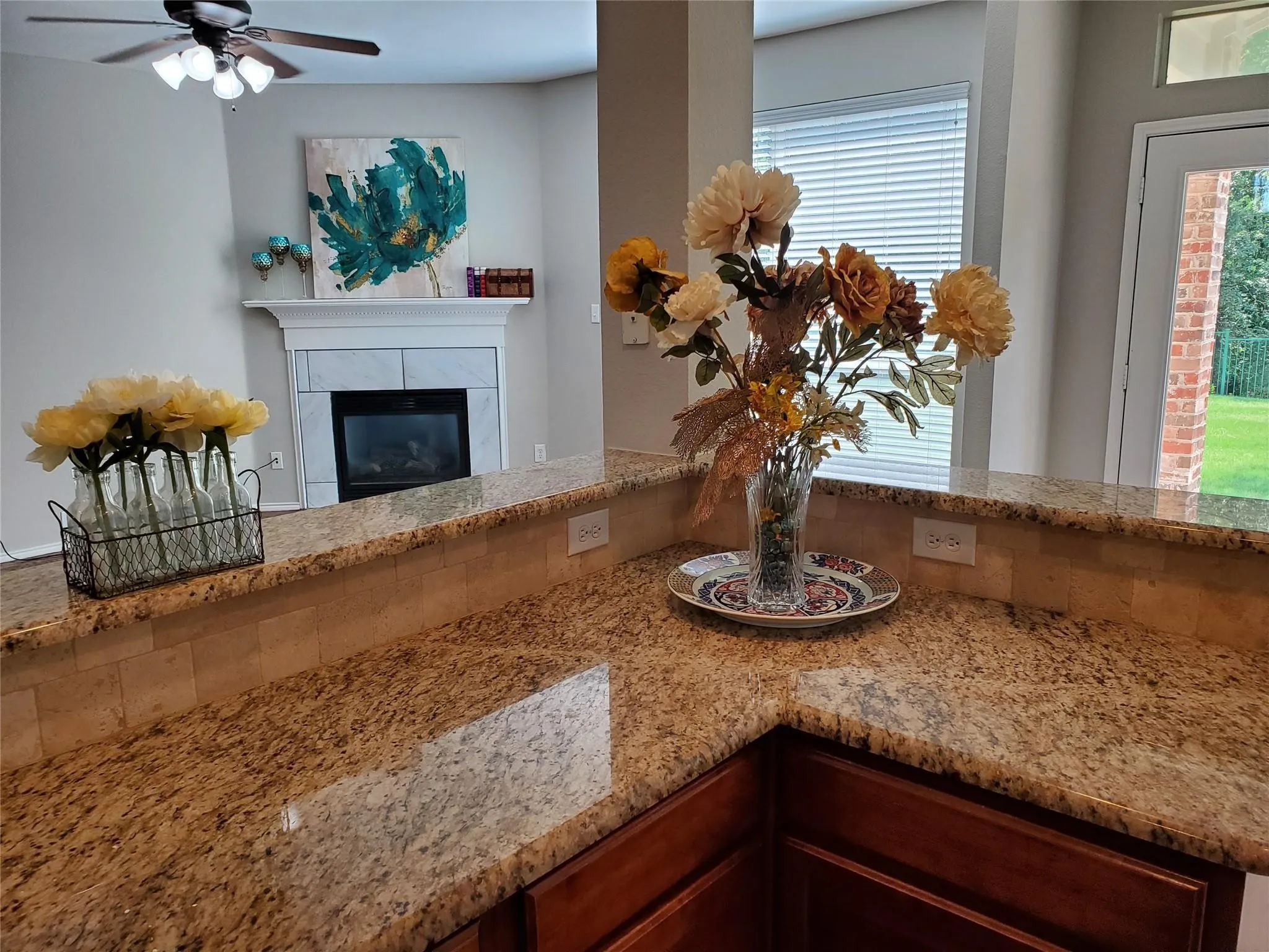 Interior details with ceiling fan and a tile fireplace
