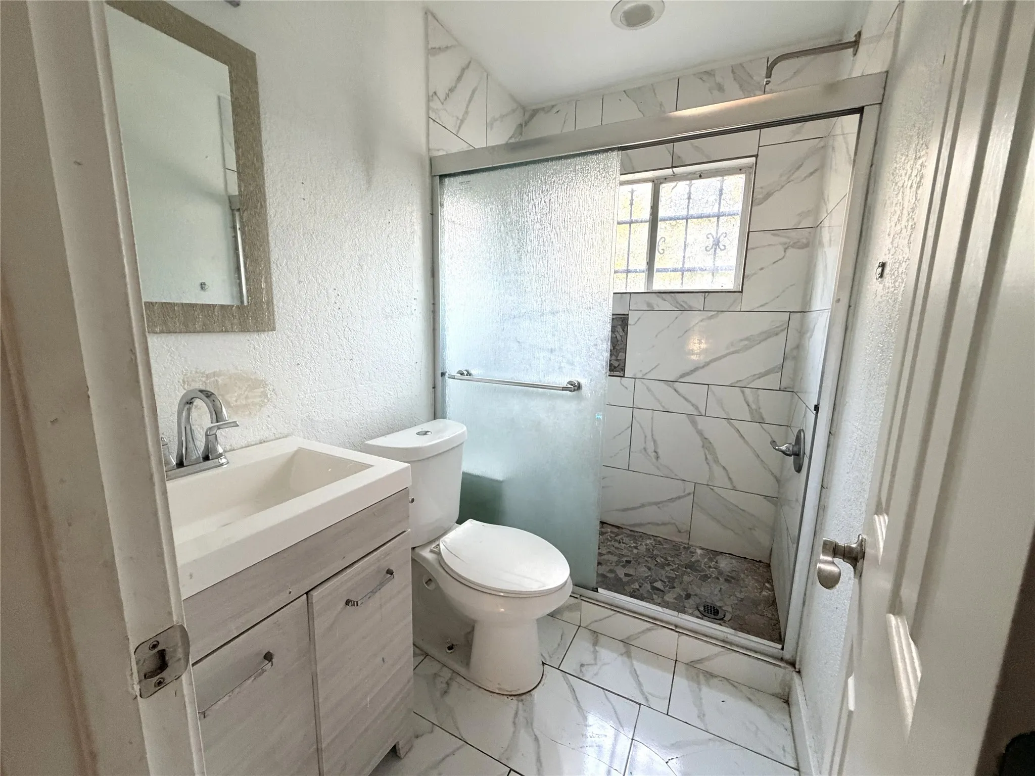 Vanity with integrated sink, chrome faucet, and cabinet storage
