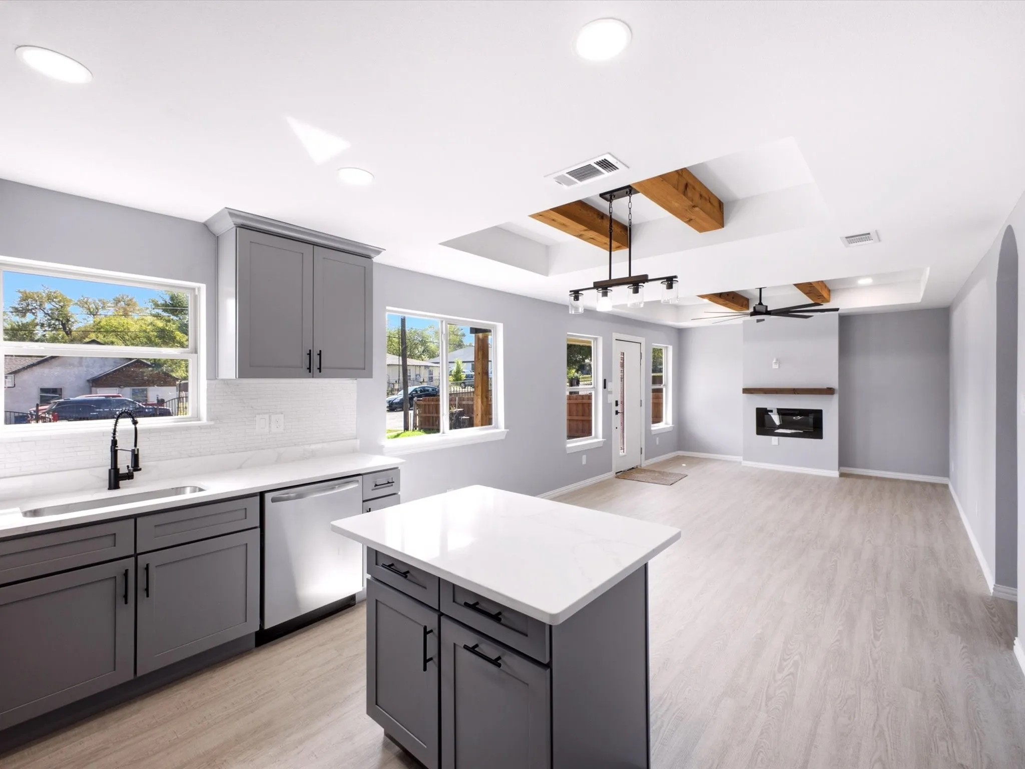 Kitchen with gray cabinetry, white countertops, and stainless steel appliances