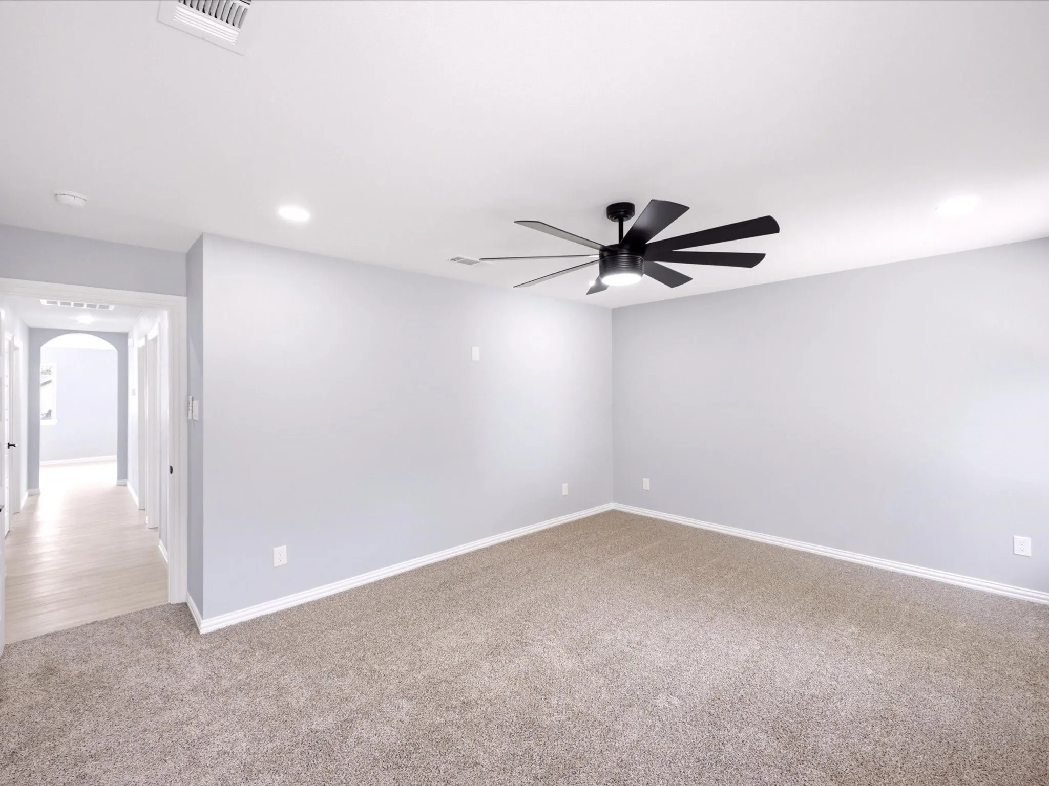 Recessed lighting and a contemporary ceiling fan