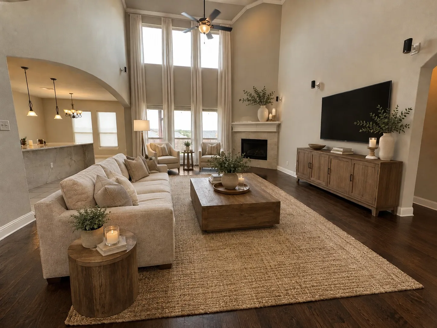 STAGED Expansive living area featuring vaulted ceilings, floor-to-ceiling windows, and rich wood-finish flooring