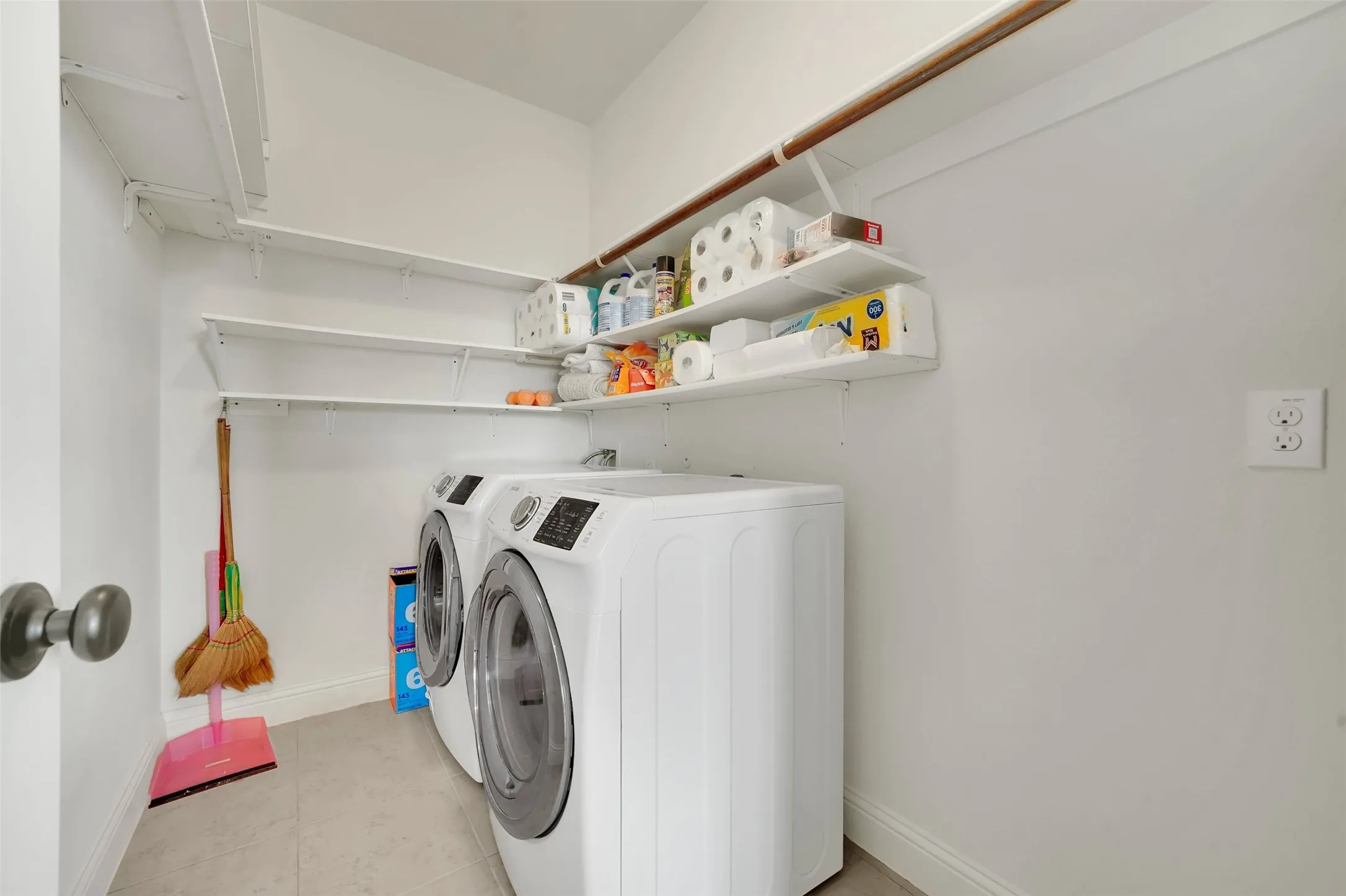 Laundry area with integrated shelving and a clothes rod