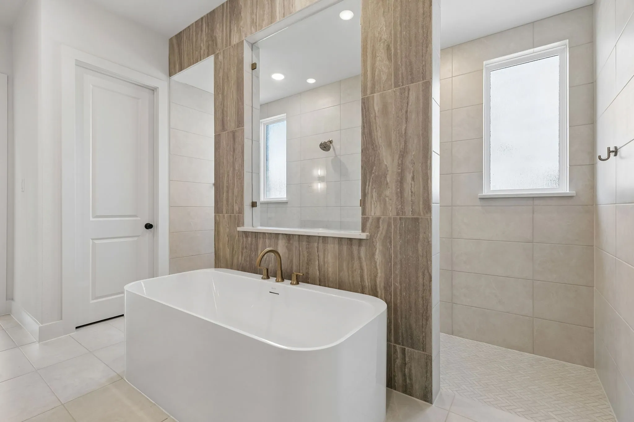 The Madison II floor plan features our signature owner's bath with double, walk through shower and drying areas!