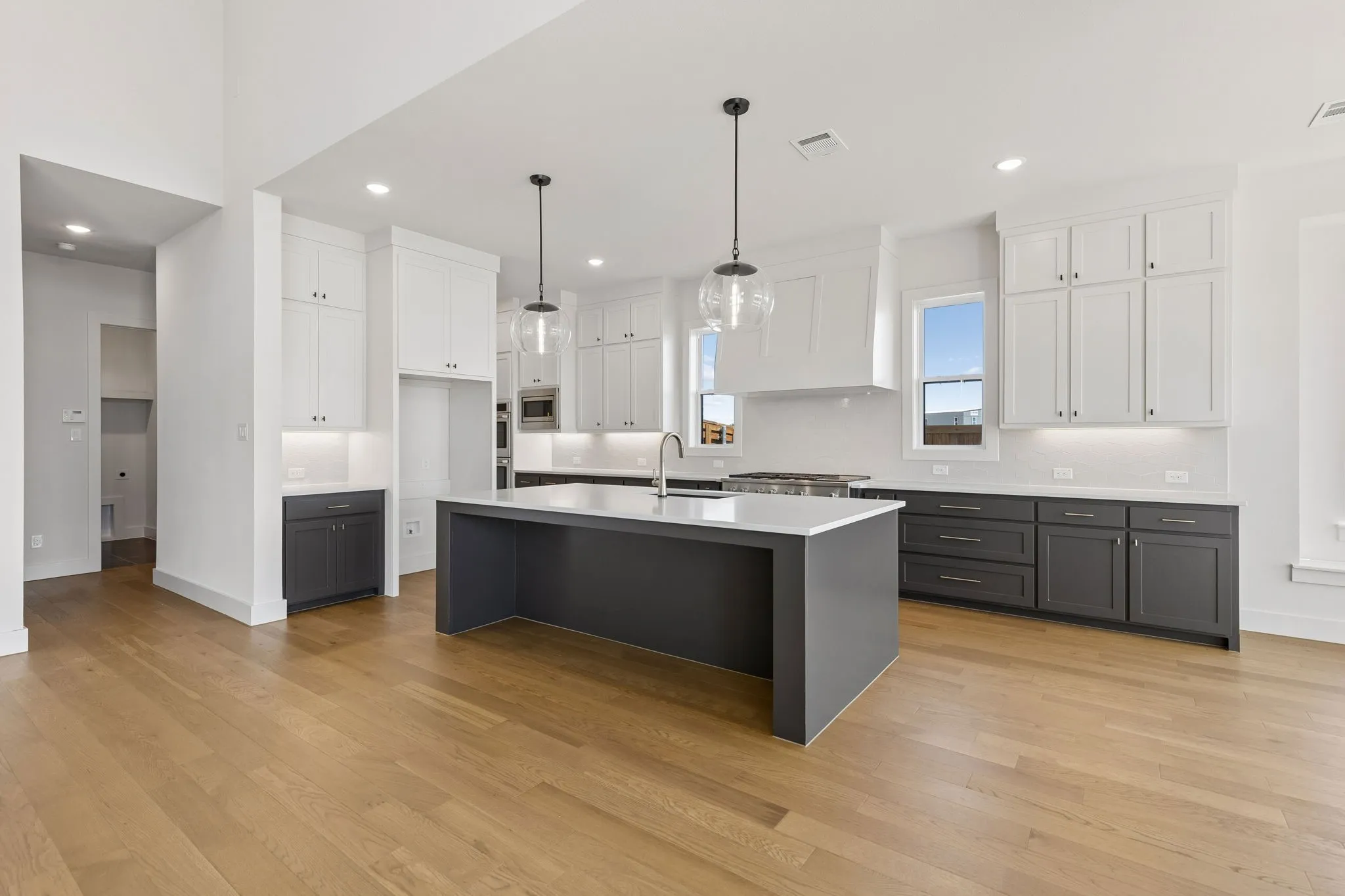 With striking two tone cabinetry, beautiful white countertops and top of the line appliances, this dream kitchen offers plenty of space for all the chefs in the family!