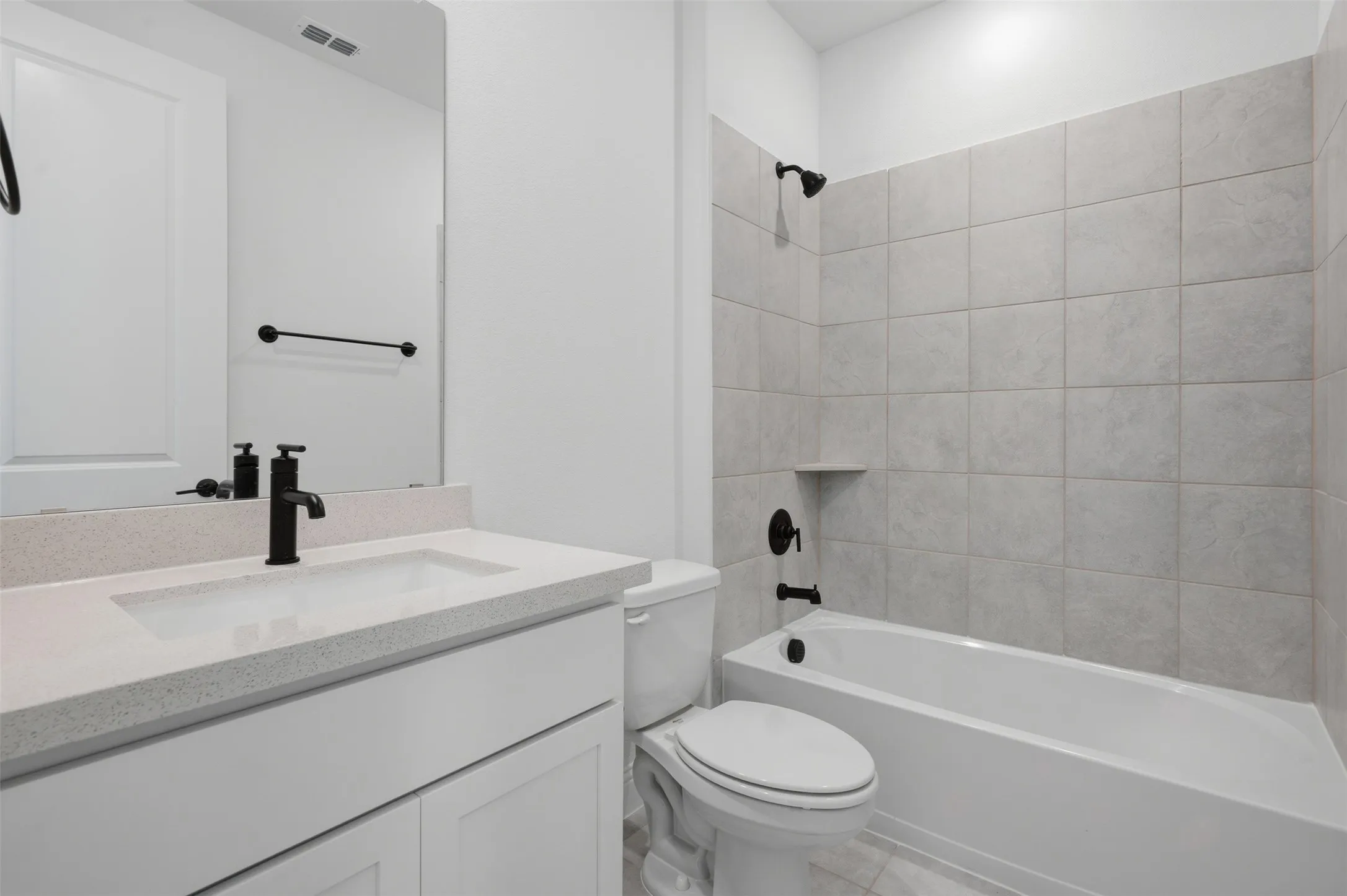 White vanity with an integrated rectangular sink and light-toned countertop