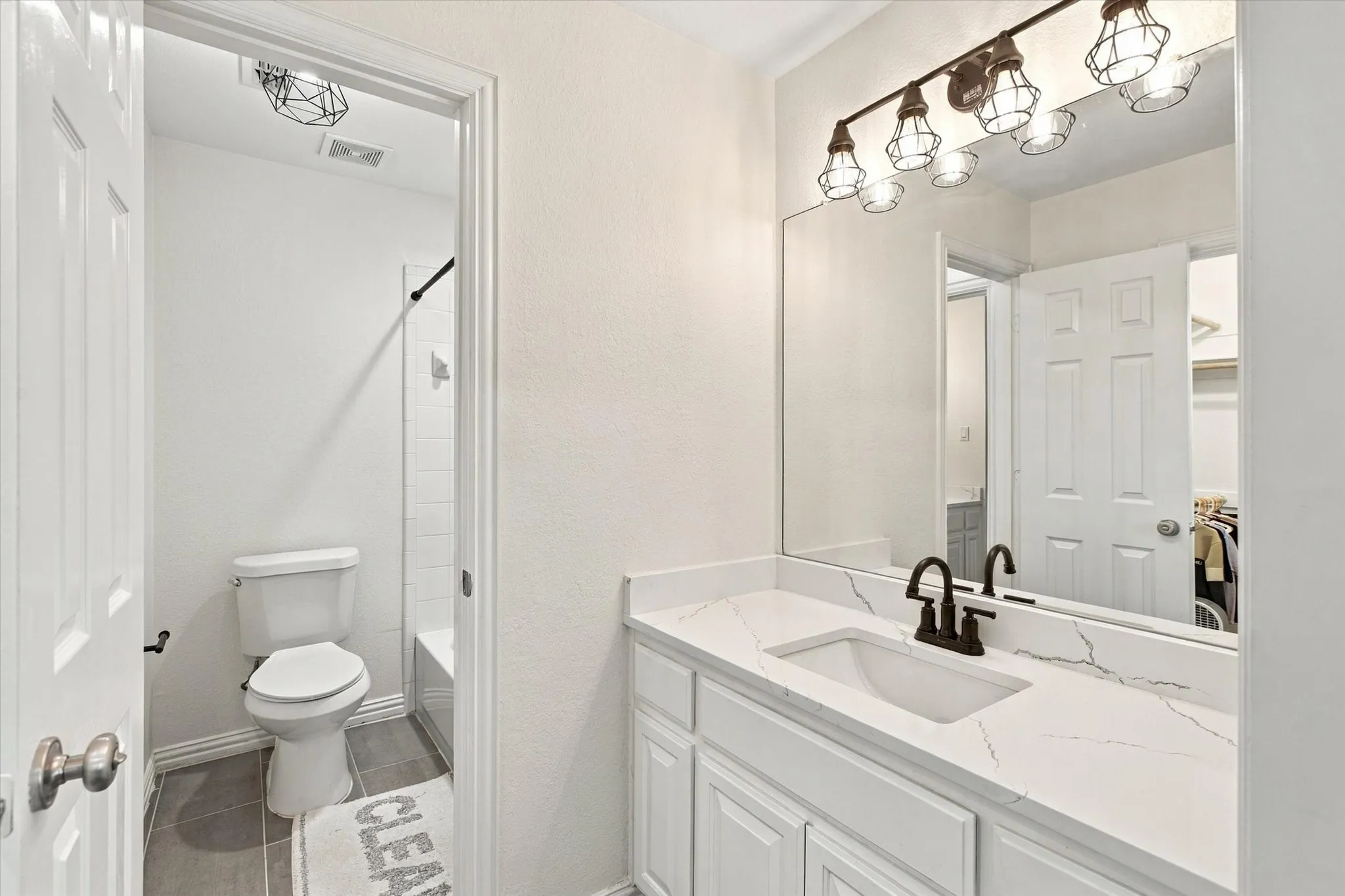 Vanity with an integrated sink, a white countertop, and white cabinetry
