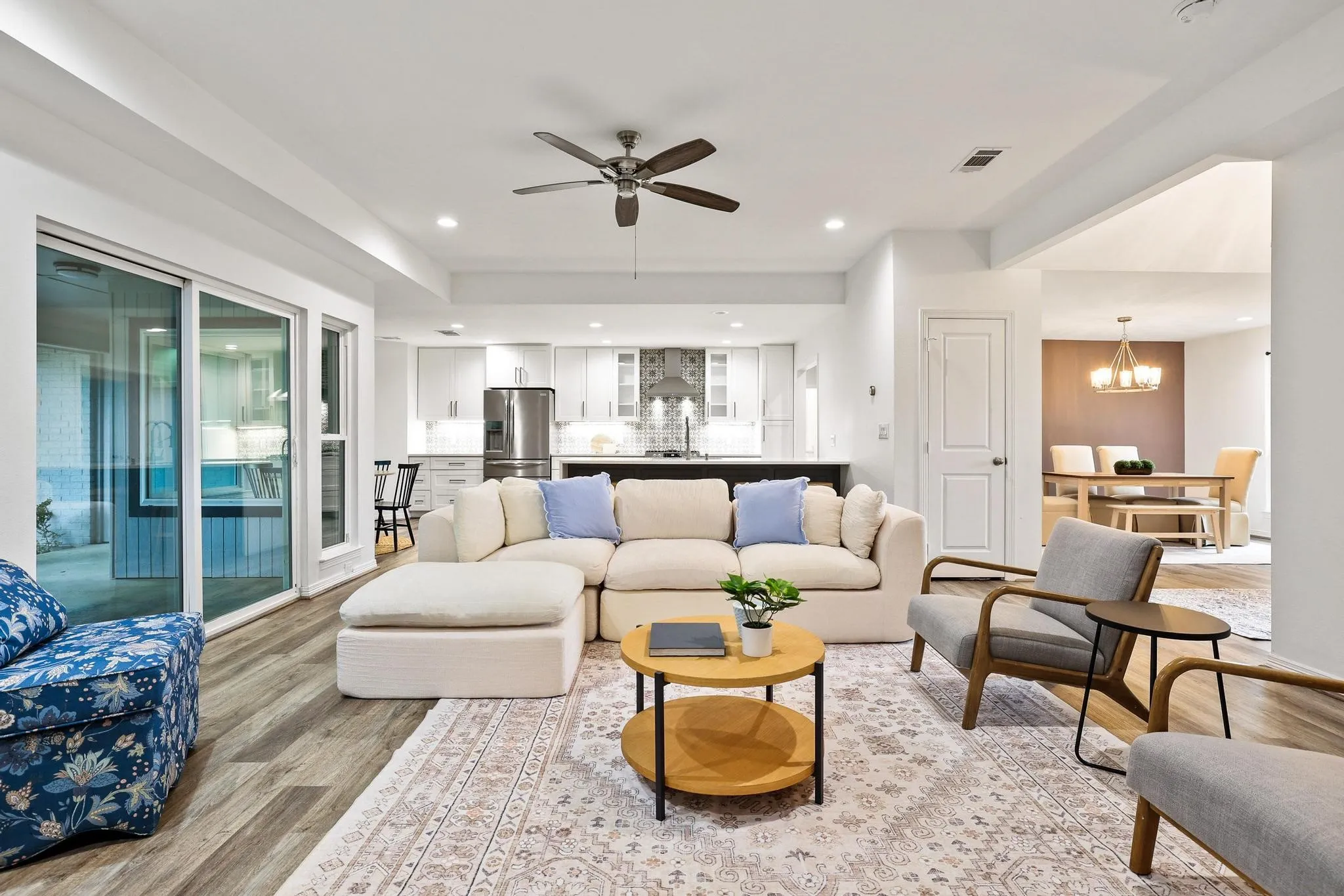 Wood-finish flooring, recessed lighting, and a ceiling fan
