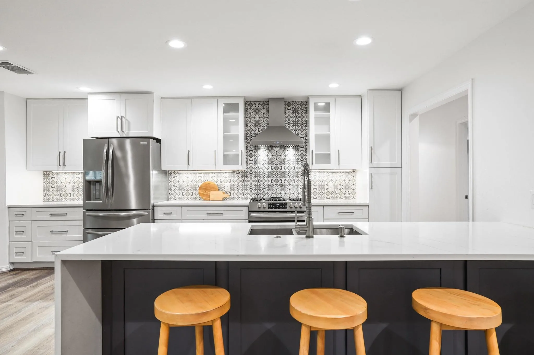 White shaker cabinetry with stainless steel hardware