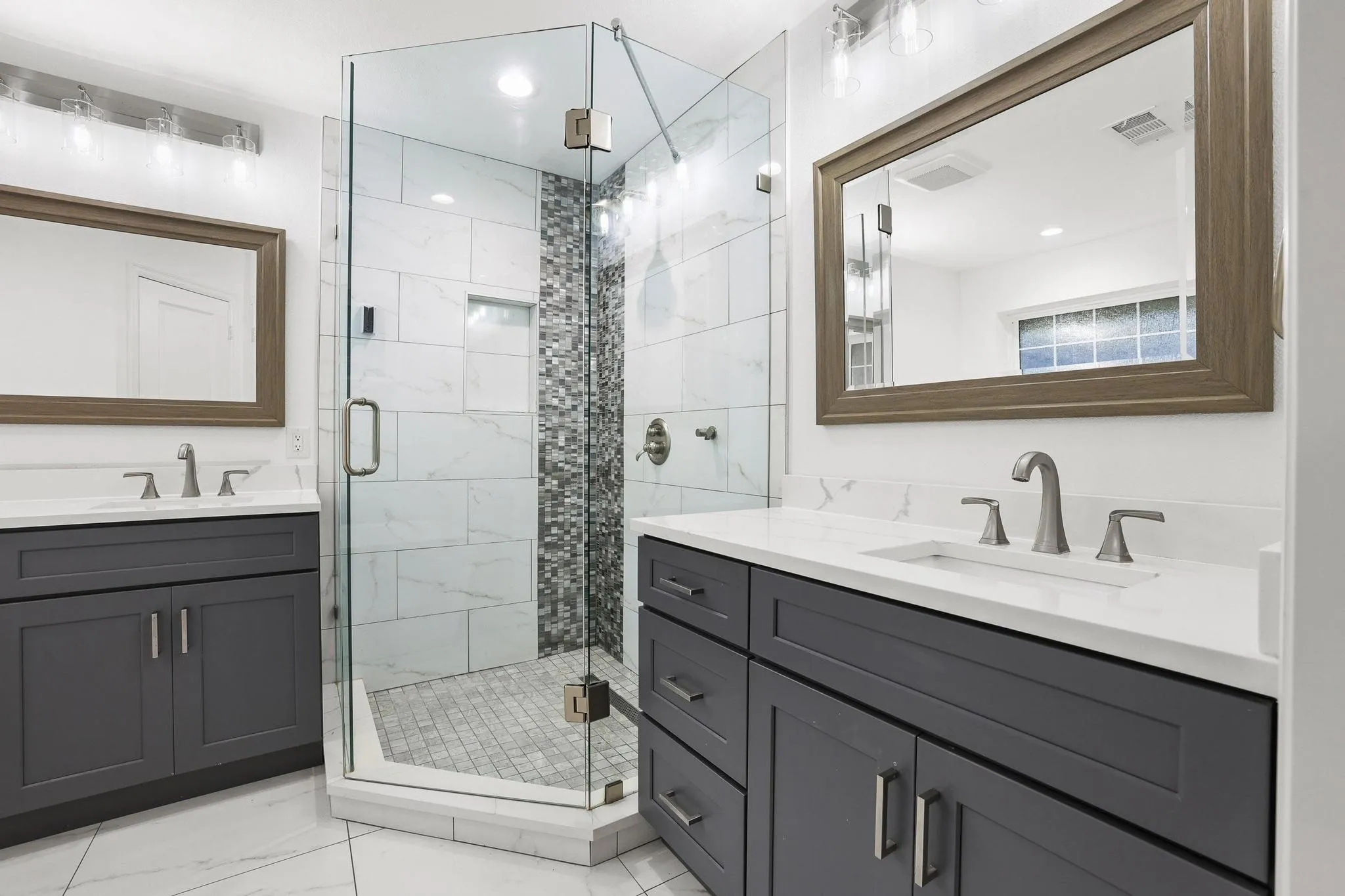 Dual vanity with gray cabinetry and white countertops