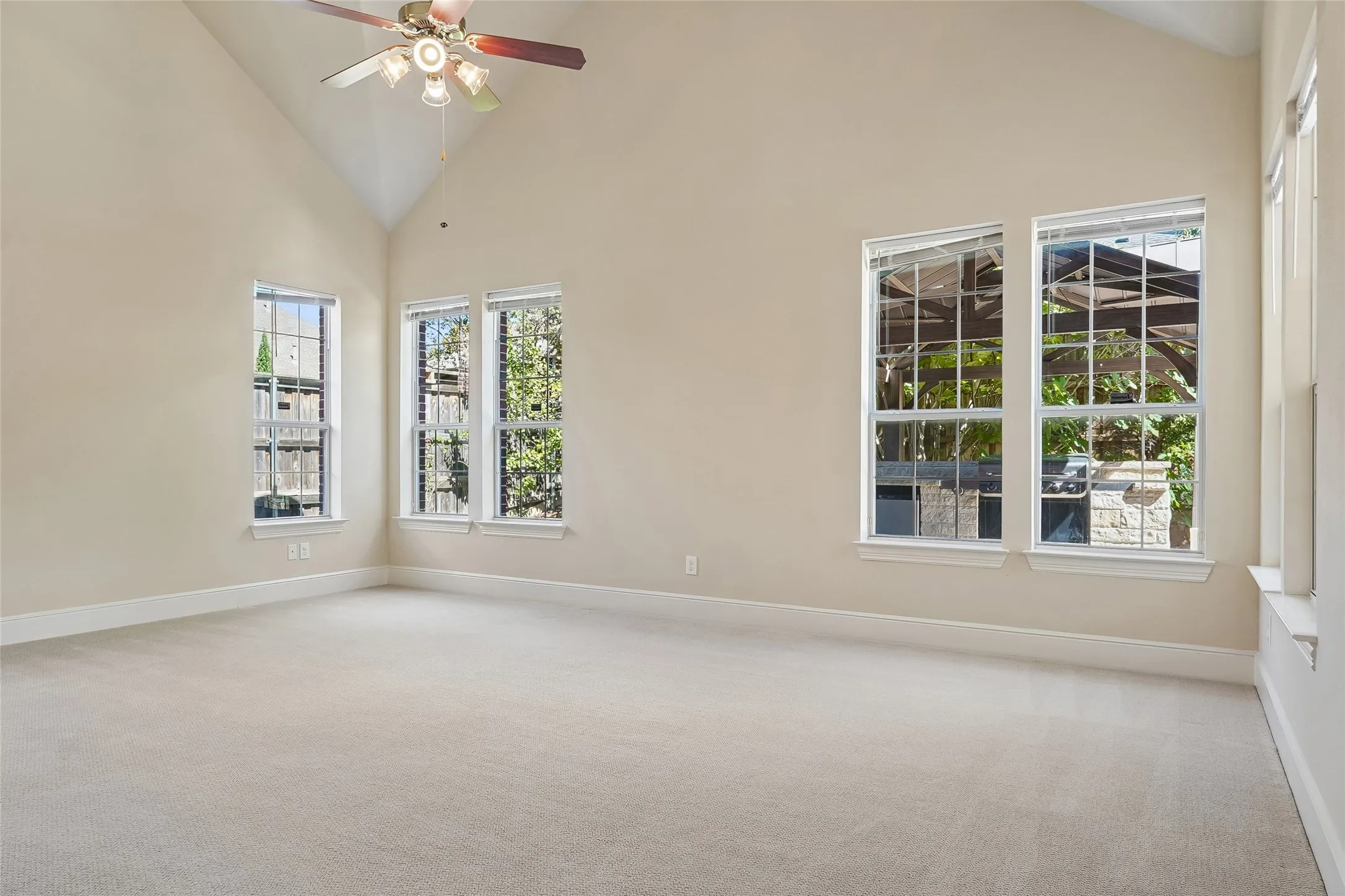 Vaulted ceiling with a ceiling fan and light fixture