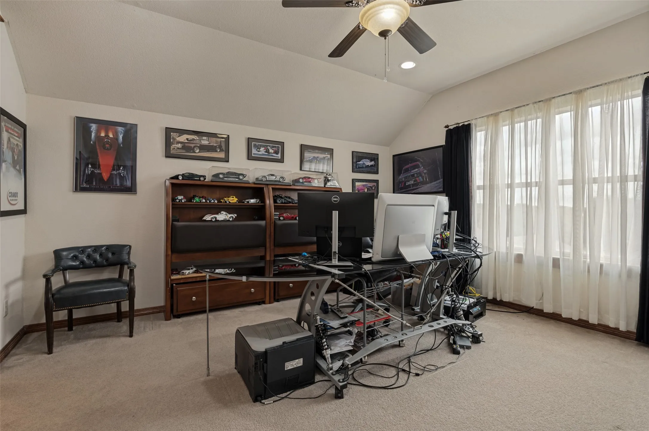 Bright home office with a large window and a vaulted ceiling