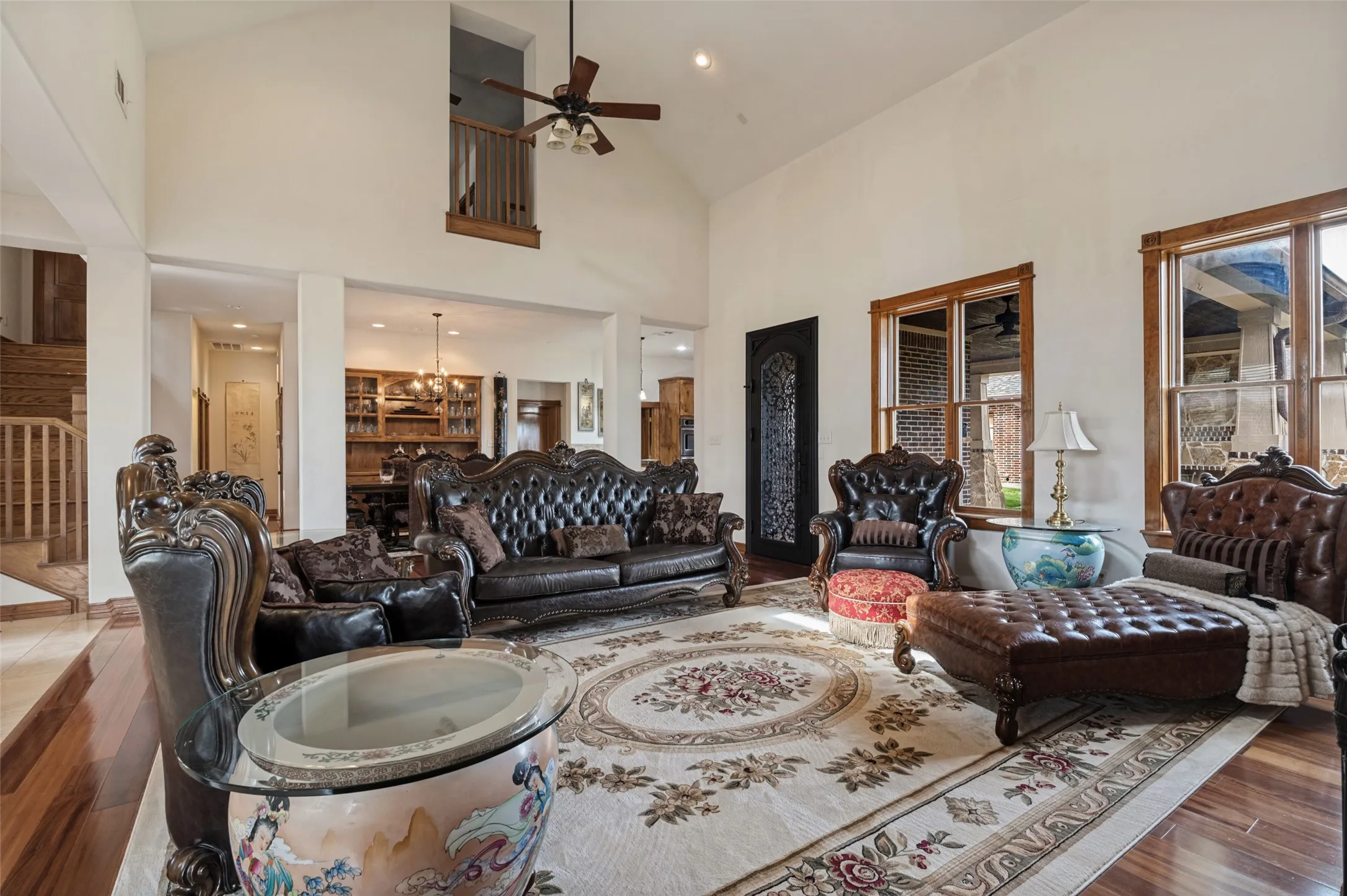 Open family room with hardwood floors and views to the kitchen and upstairs loft