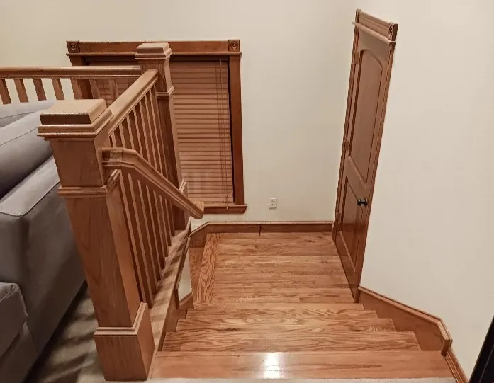Hardwood stairs up to the second floor, with a custom wood railing