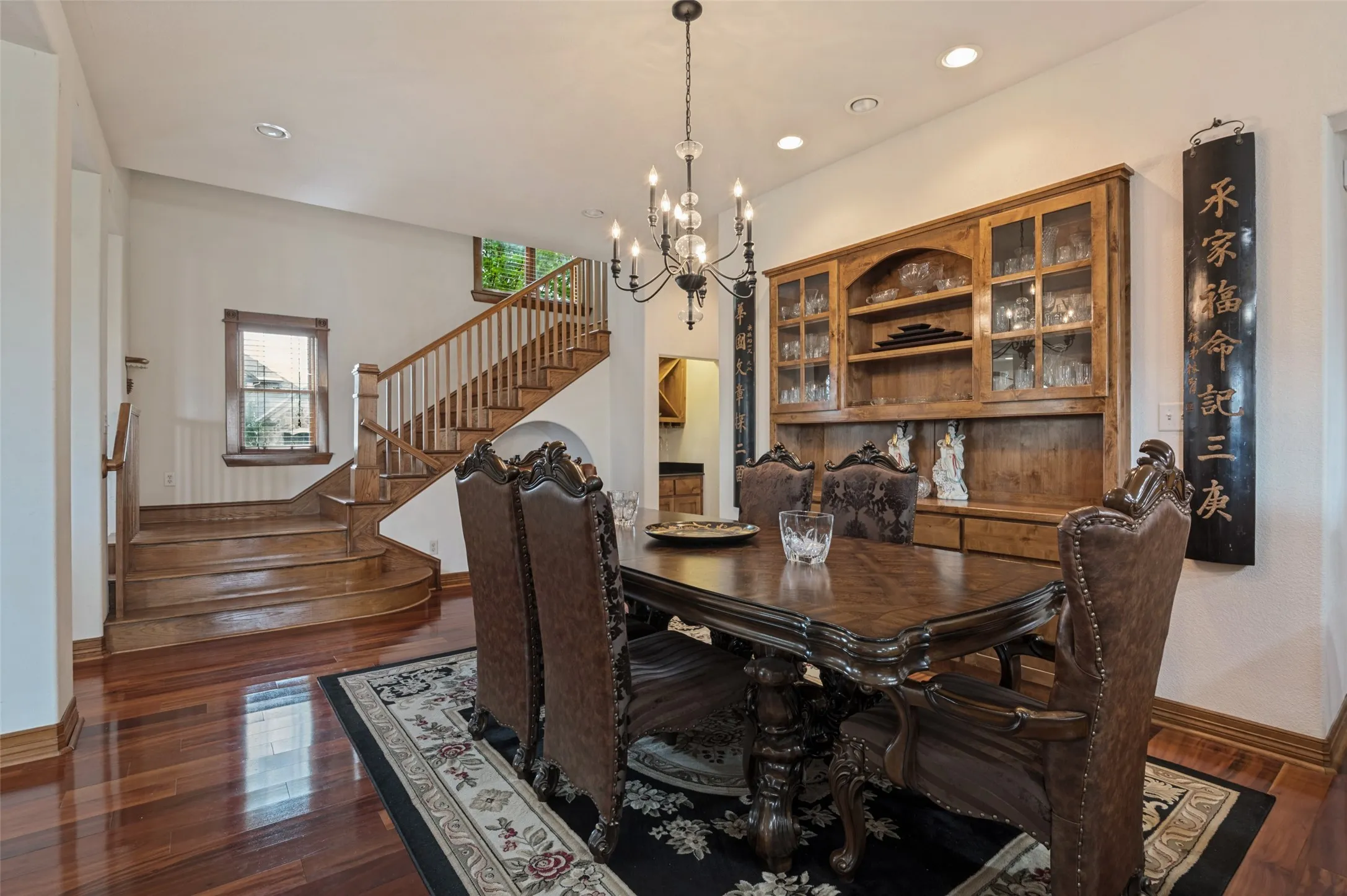 Dining room with a view of the wood staircase to the second floor

