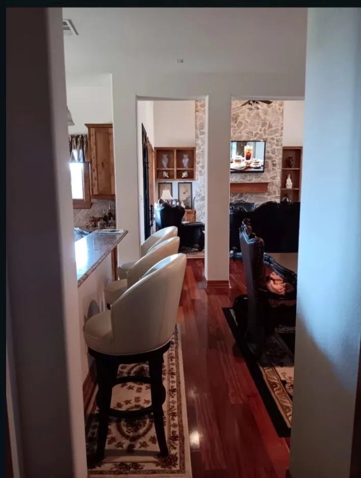 Breakfast bar seating, with open views from the kitchen into the dining and family rooms