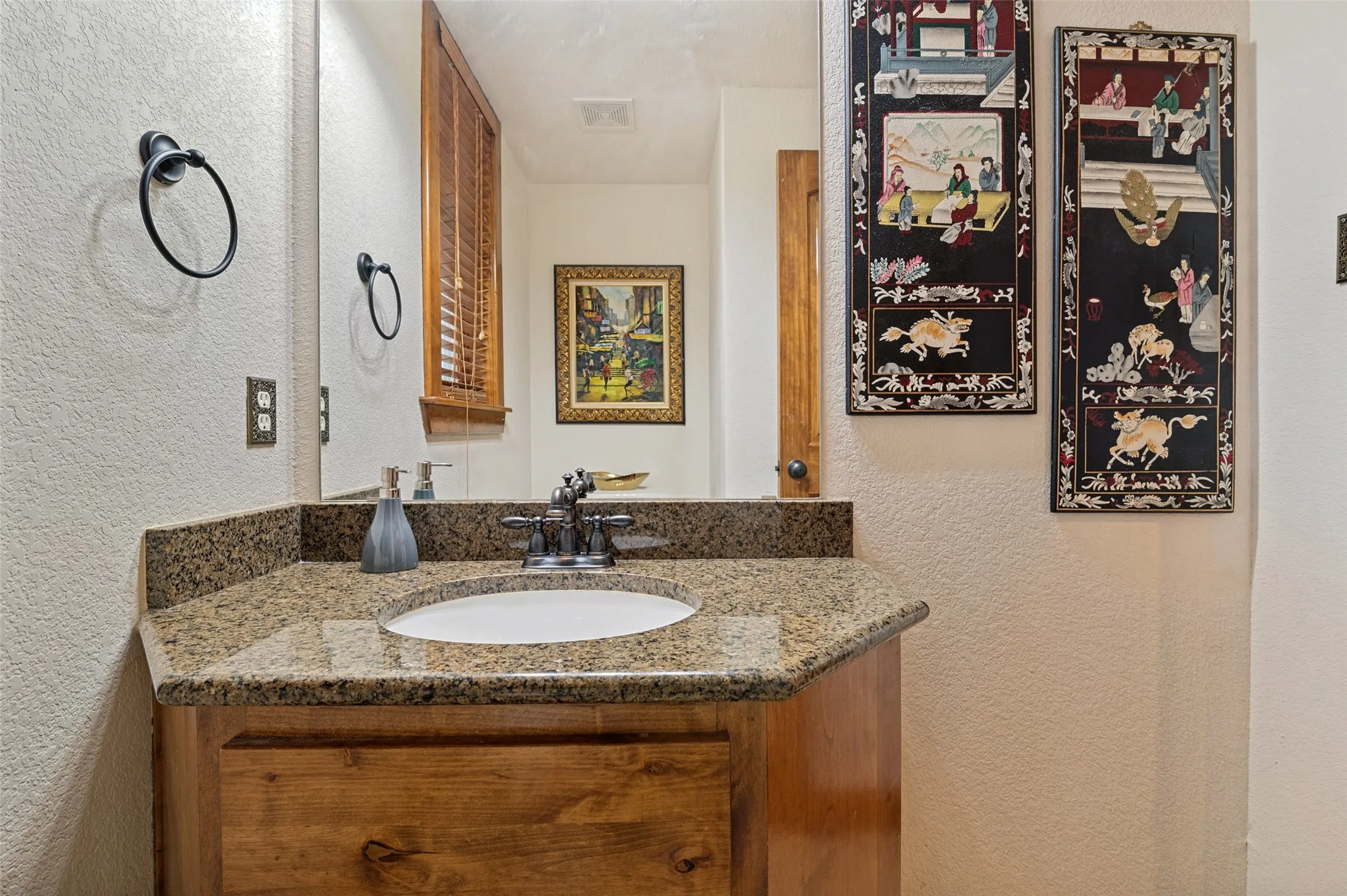 Half bath with a granite vanity