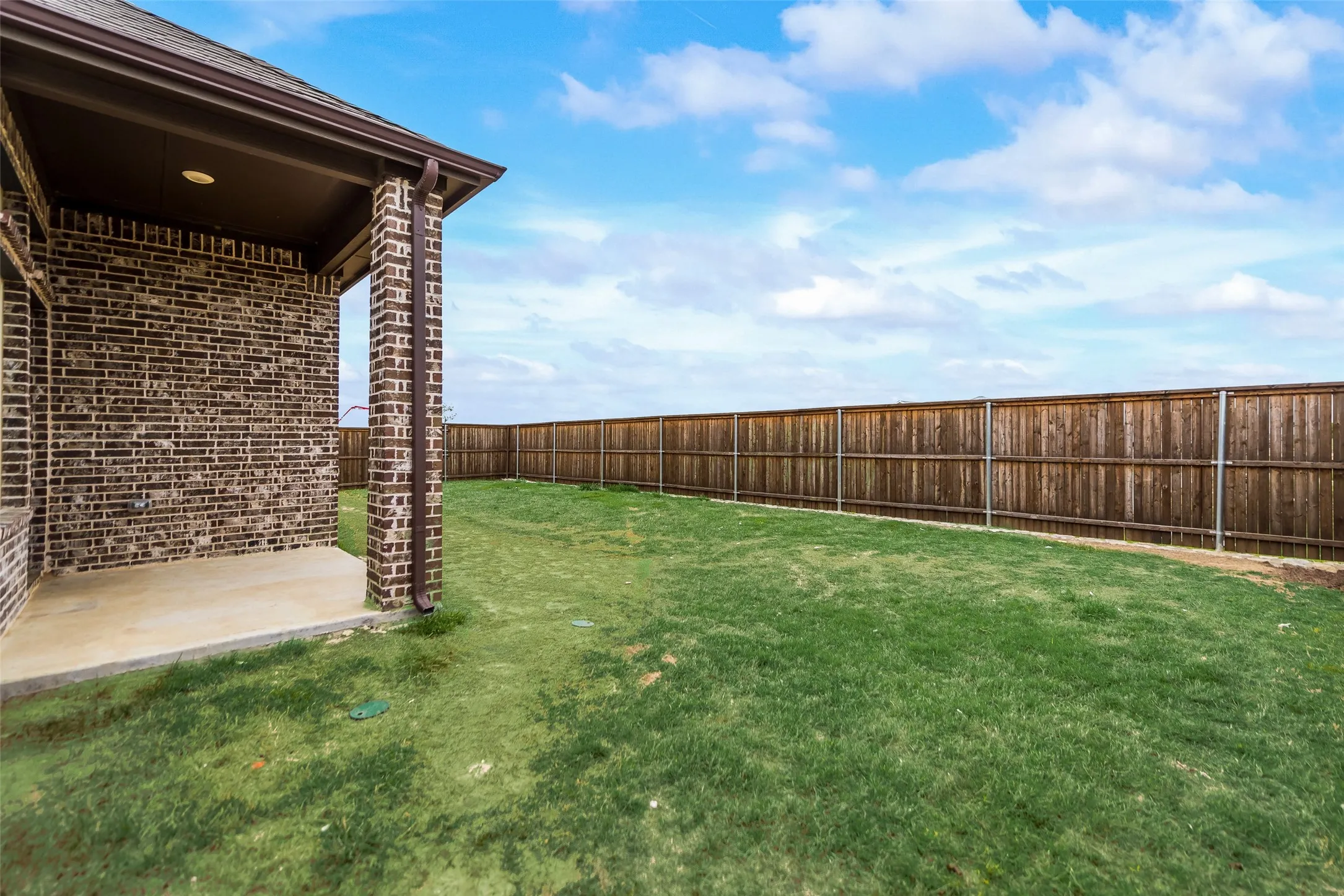 Expansive lawn area with a new privacy fence