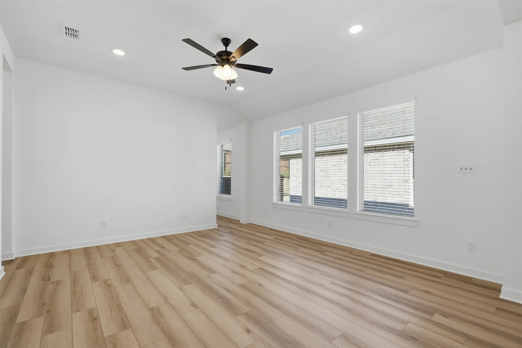 Wood-finish flooring, recessed lighting, and a ceiling fan