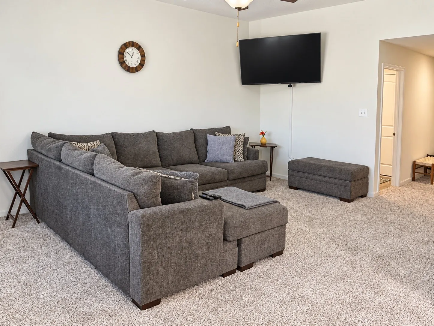Neutral wall color, carpeted flooring, and ceiling fan